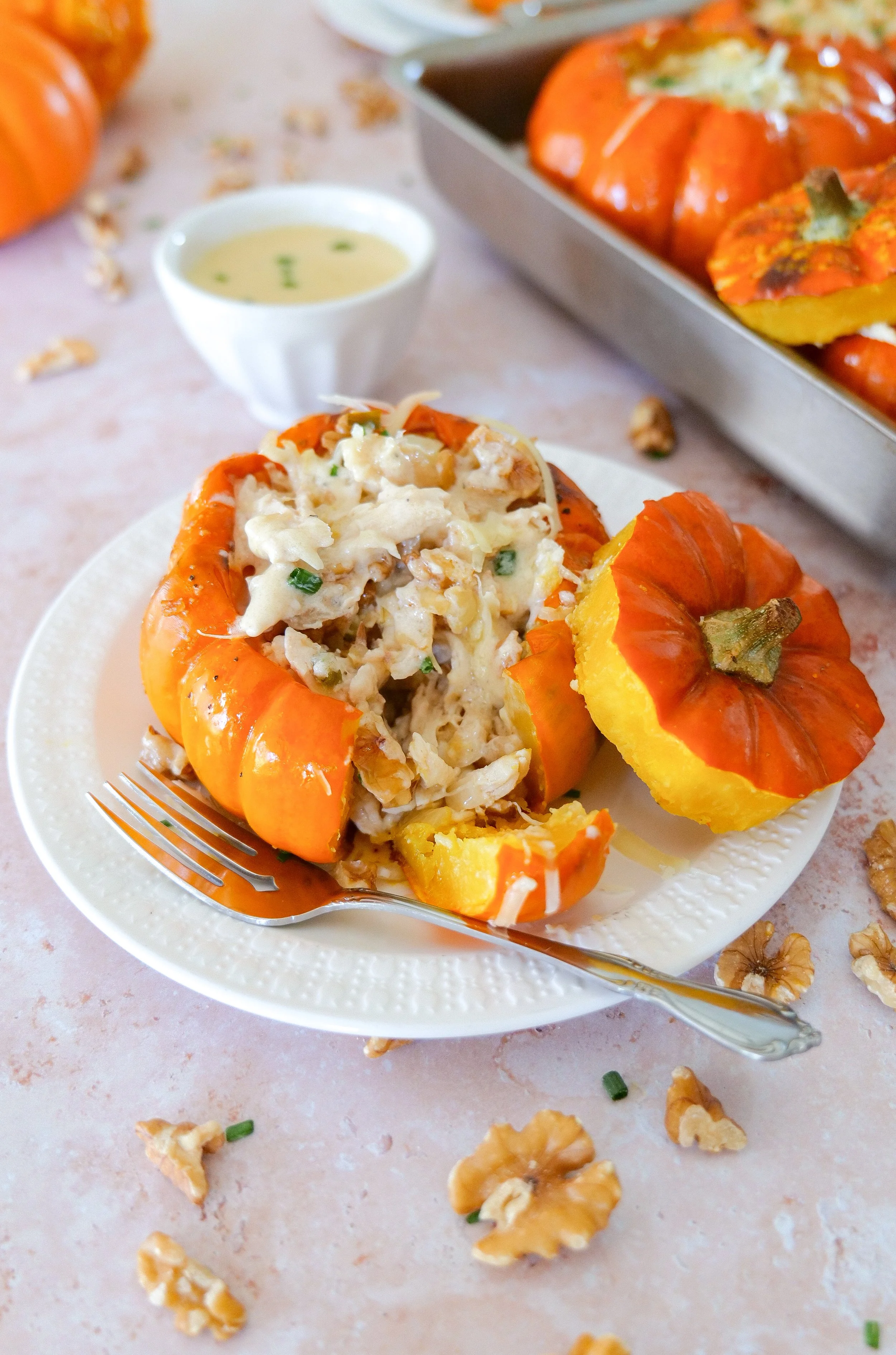 Individual roasted stuffed pumpkins ready to serve for a cozy autumn dinner.