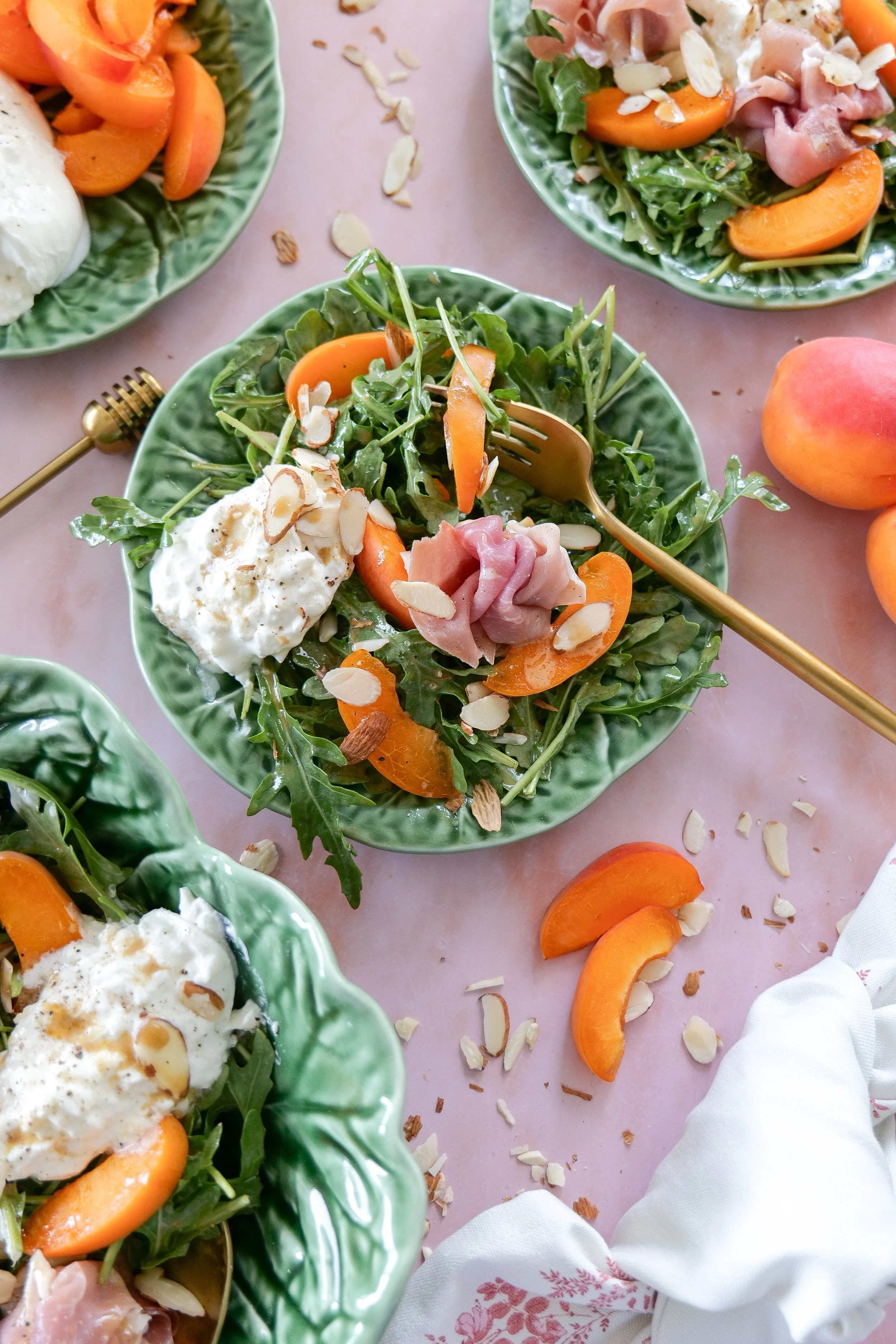 Apricot prosciutto salad with honey balsamic glaze and almonds.