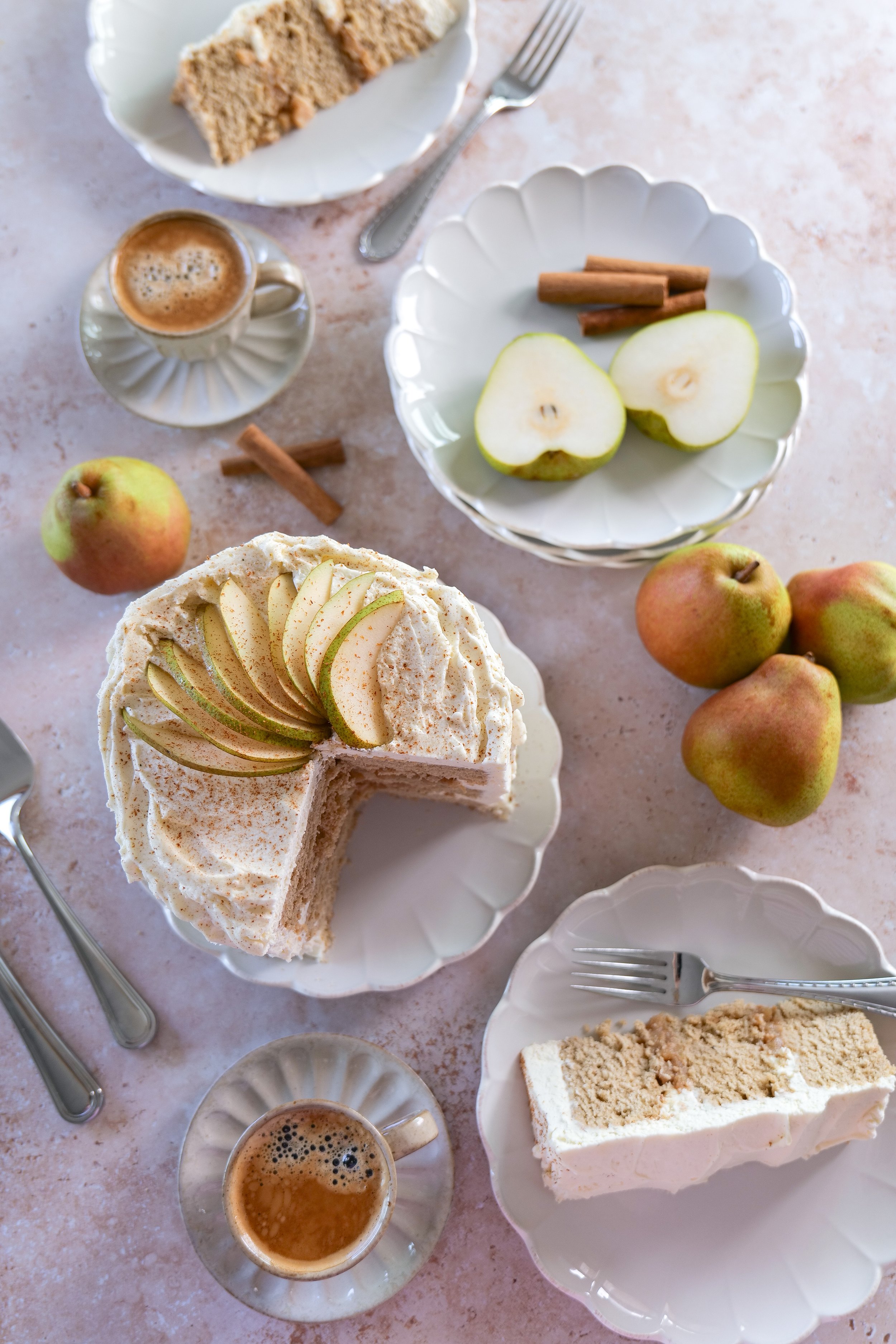 Three-layer pear cake completely frosted with fluffy vanilla mascarpone cream.