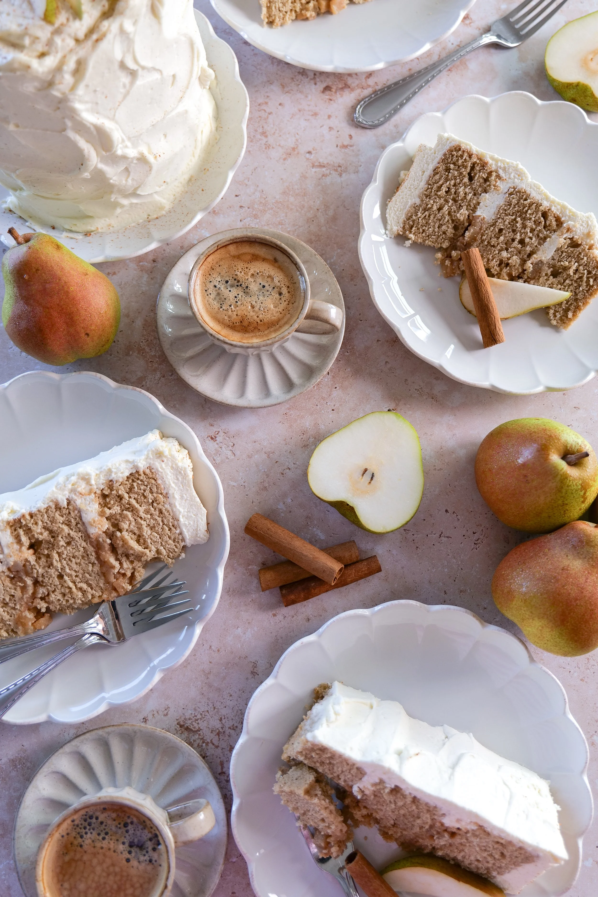 Homemade three-layer pear cake with spiced pear filling and fresh pear decoration.