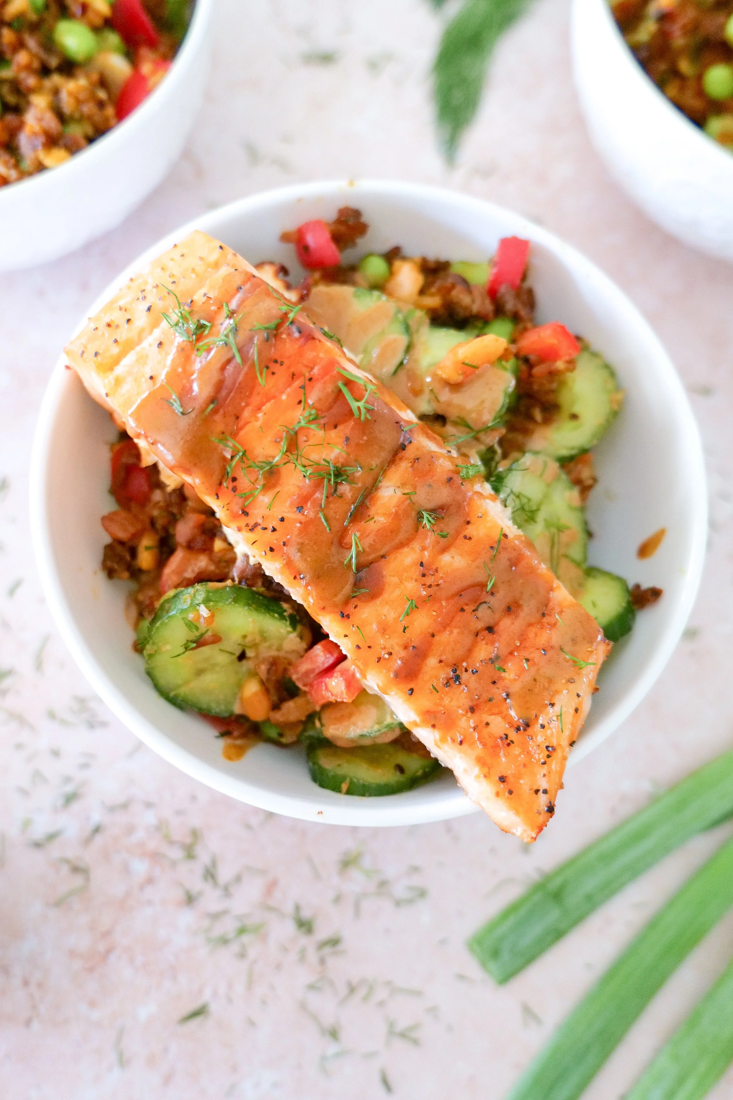 Salmon rice salad with creamy avocado, edamame, cucumber and crushed peanuts.