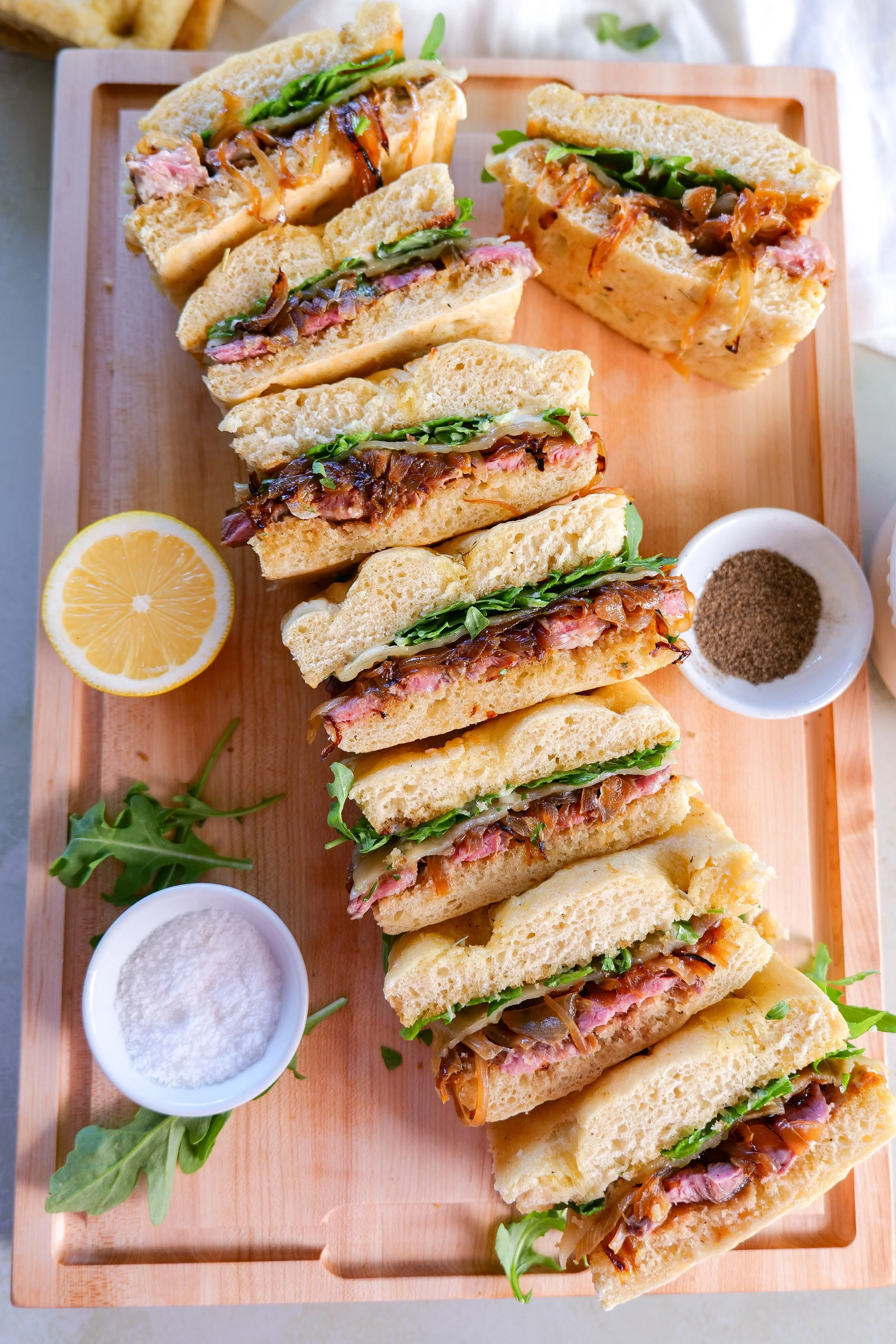 Sliced ribeye sandwich with creamy garlic aioli on focaccia