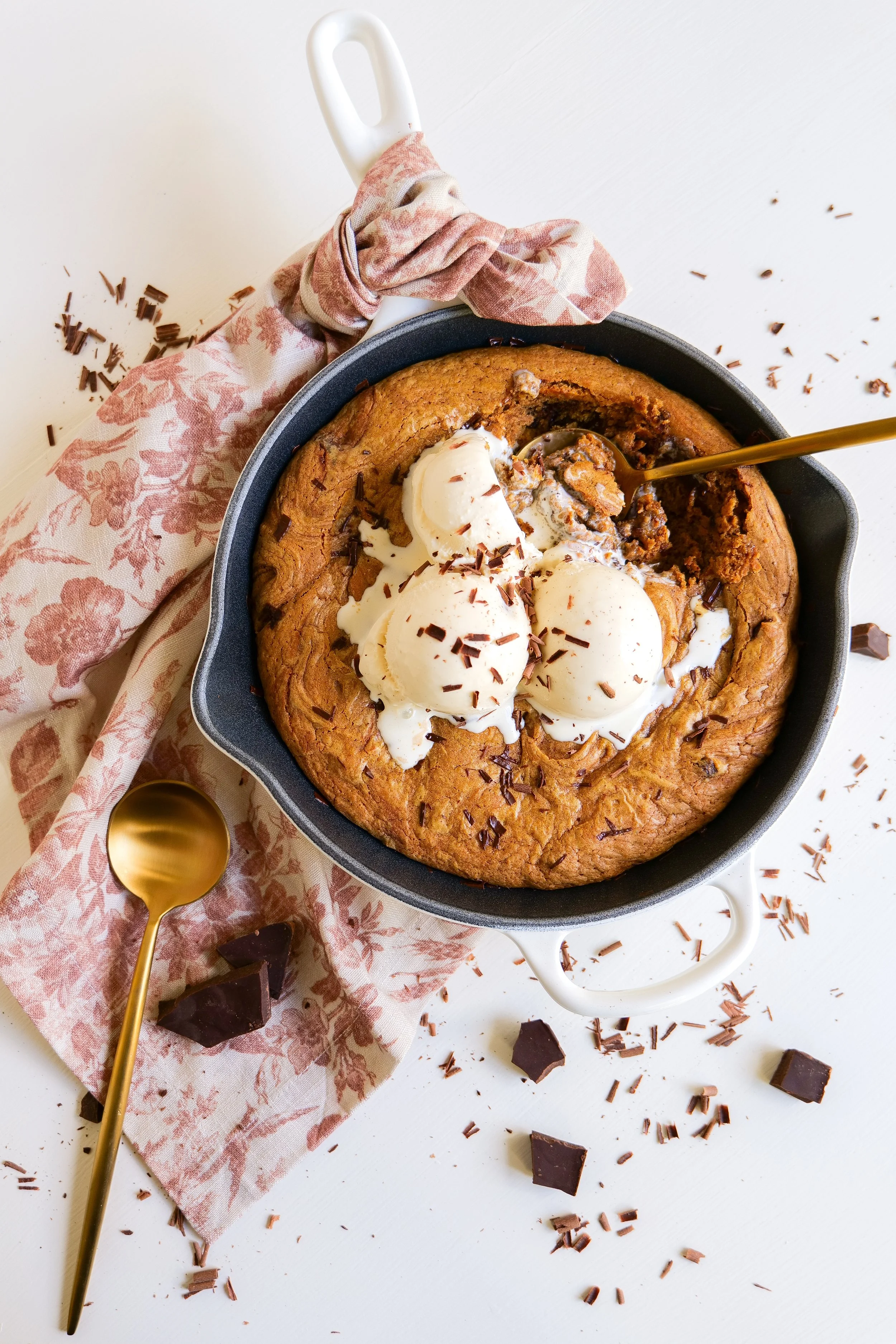 Freshly baked pumpkin chocolate chip oatmeal skillet cookie with golden edges