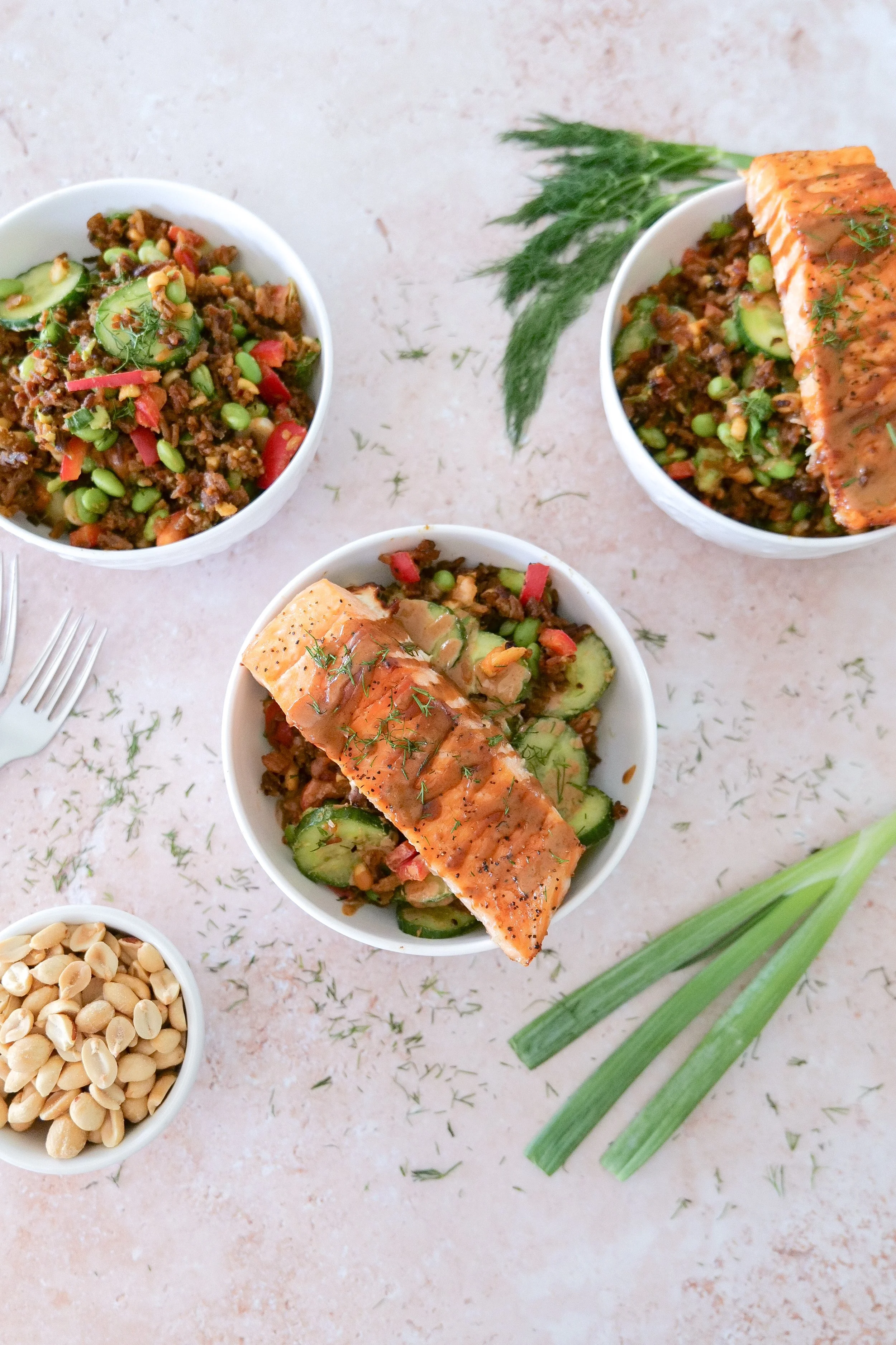 Salmon with peanut sauce served over crispy jasmine rice and fresh vegetables.