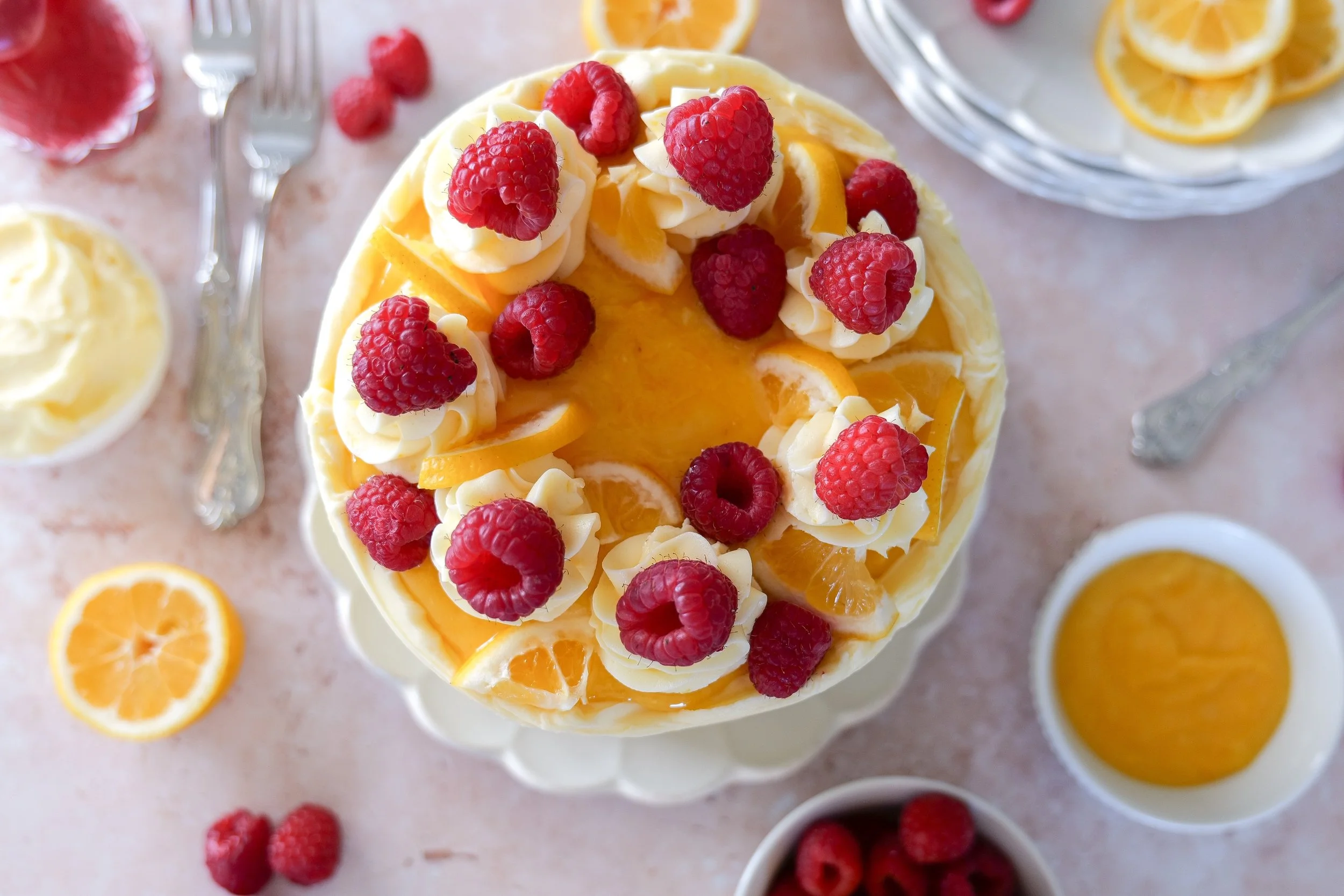 Slice of lemon raspberry cake showing lemon curd and raspberry layers.
