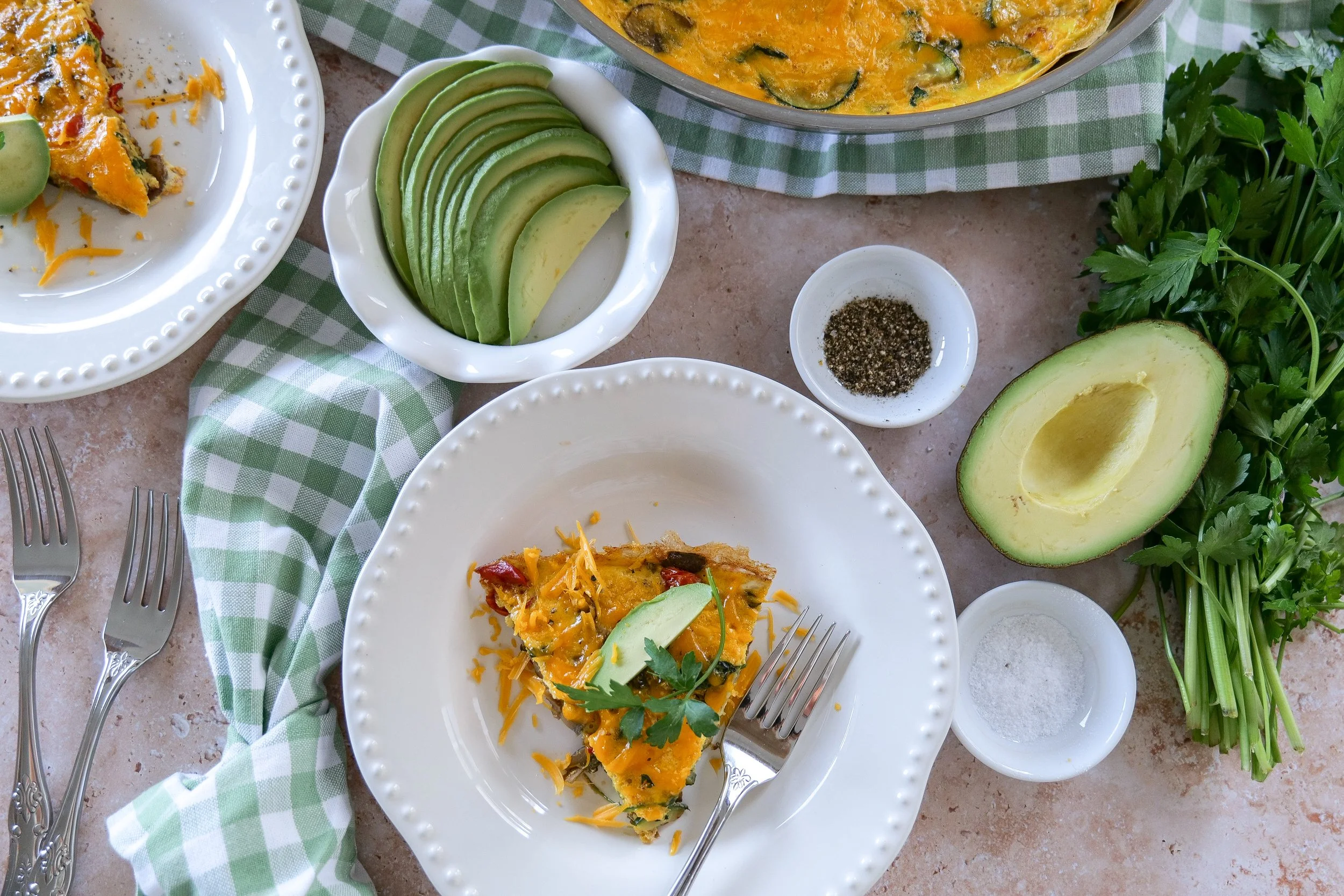 Fresh veggie frittata topped with herbs and seasonal produce
