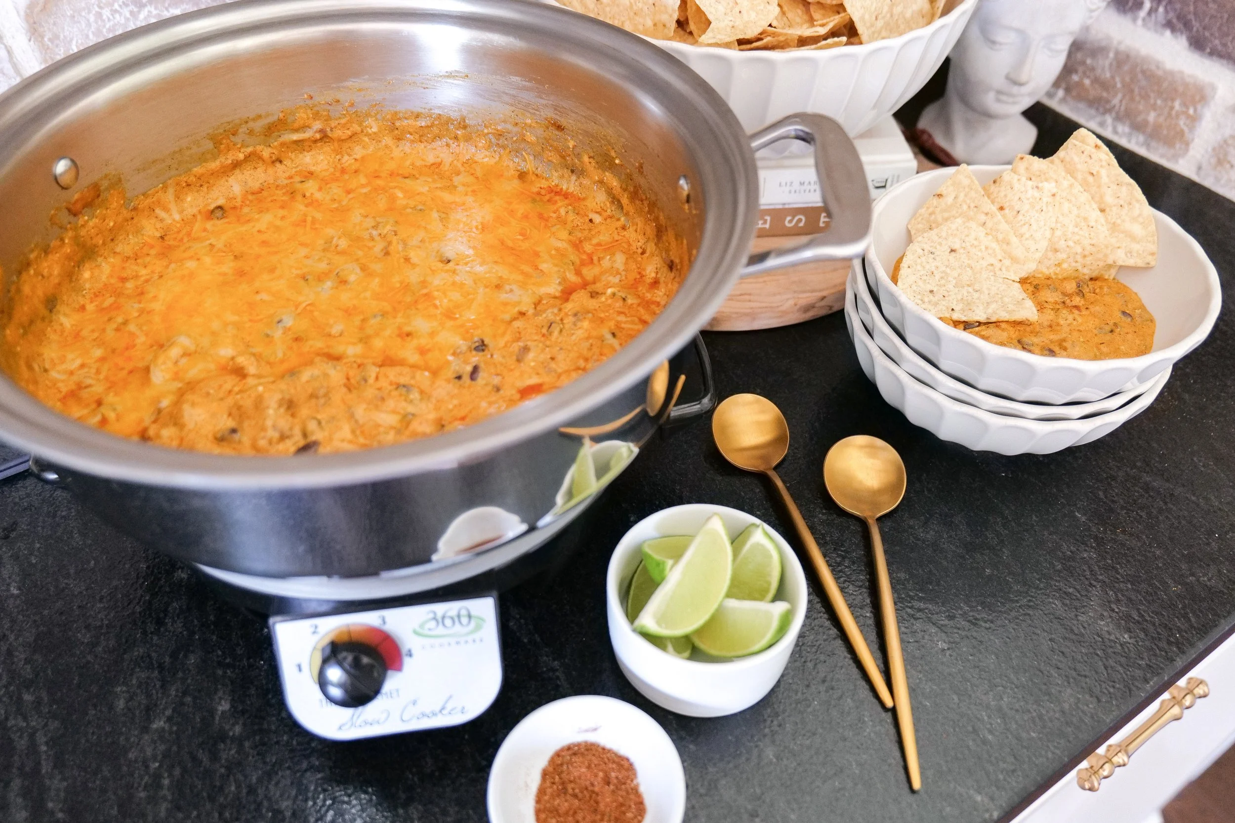 Creamy chicken enchilada party dip made in the slow cooker with tender shredded chicken and melted cheese.