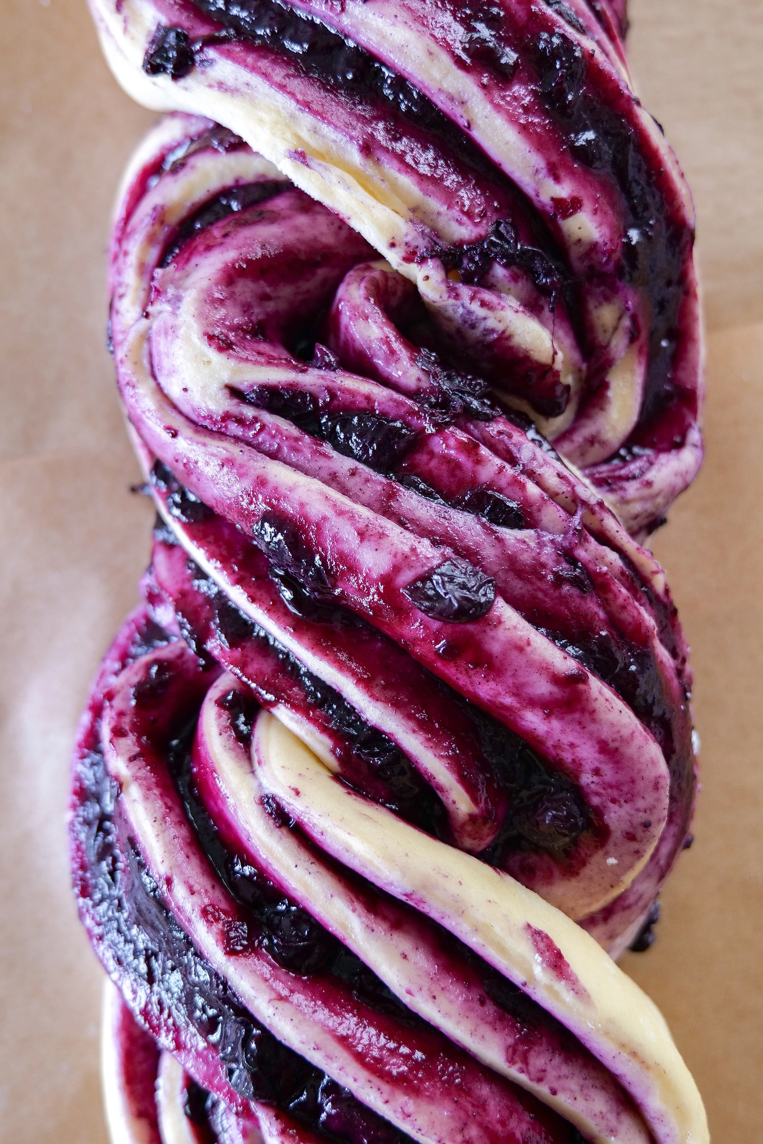 Homemade blueberry cinnamon filling cooking in a saucepan for blueberry cinnamon roll loaf.