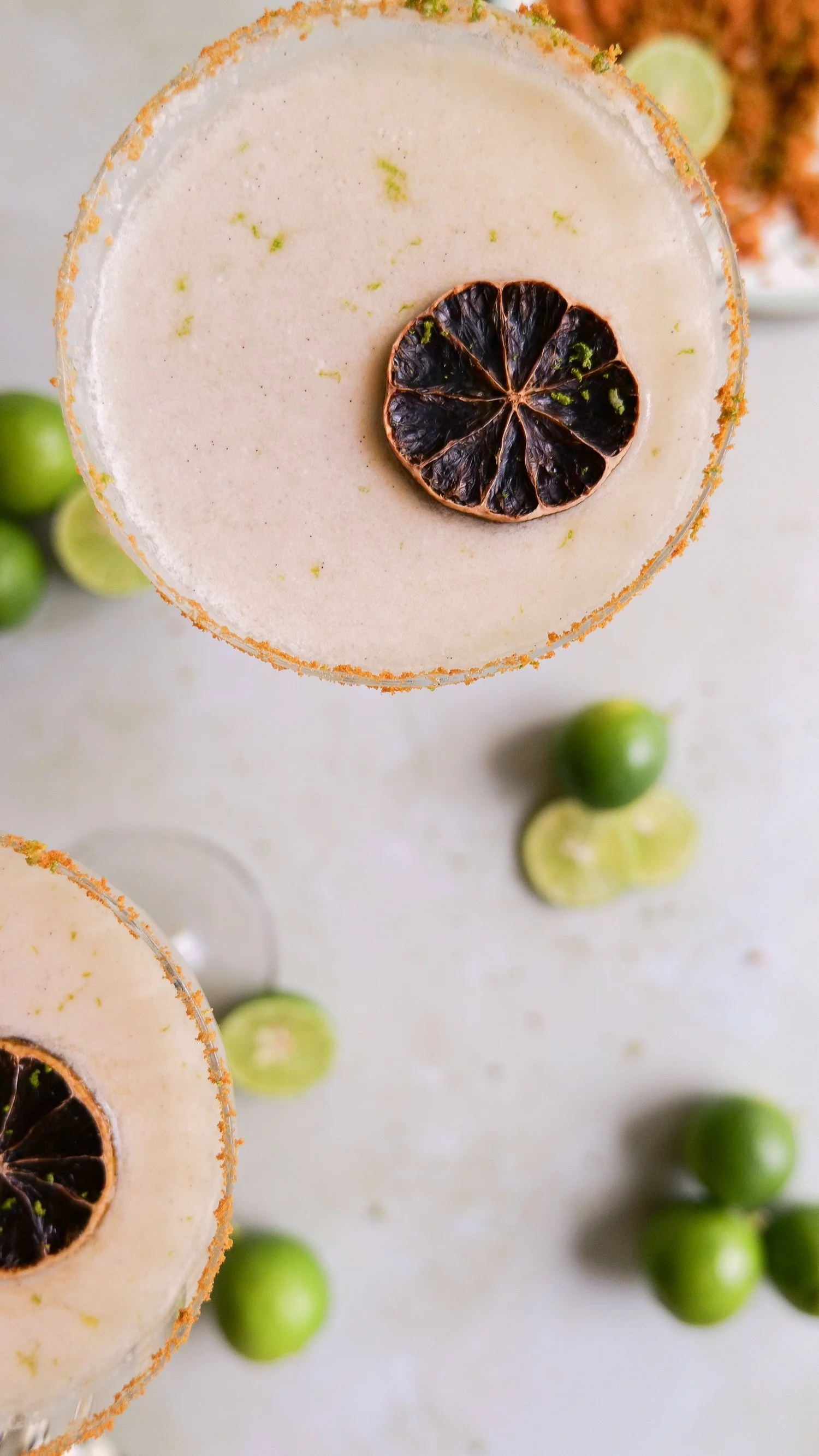 Key lime pie martini with graham cracker and lime zest rim