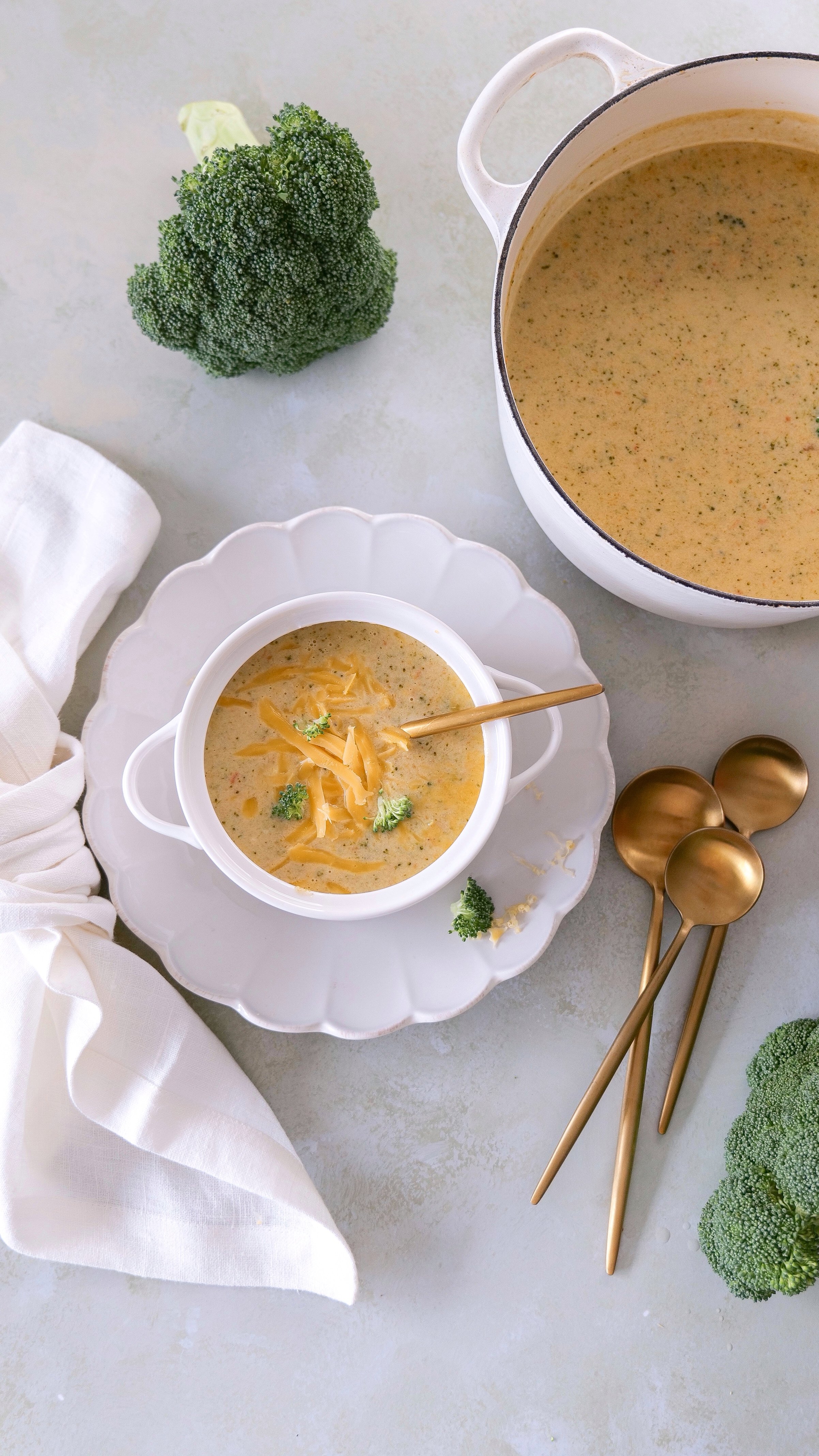 Close-up of creamy broccoli cheese soup with tender pieces of fresh broccoli.