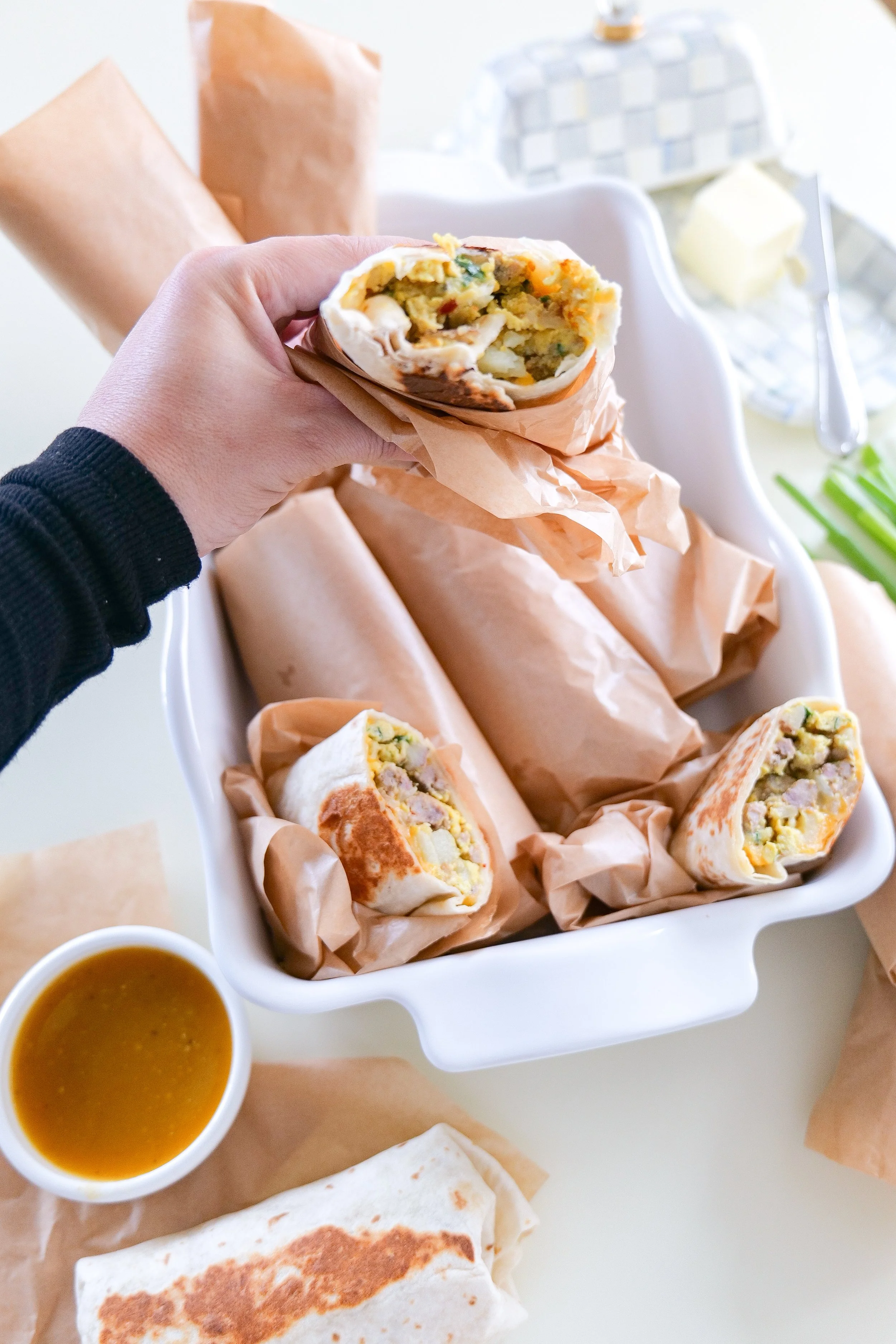 Wrapped homemade breakfast burritos ready to reheat for a hearty breakfast on busy mornings.