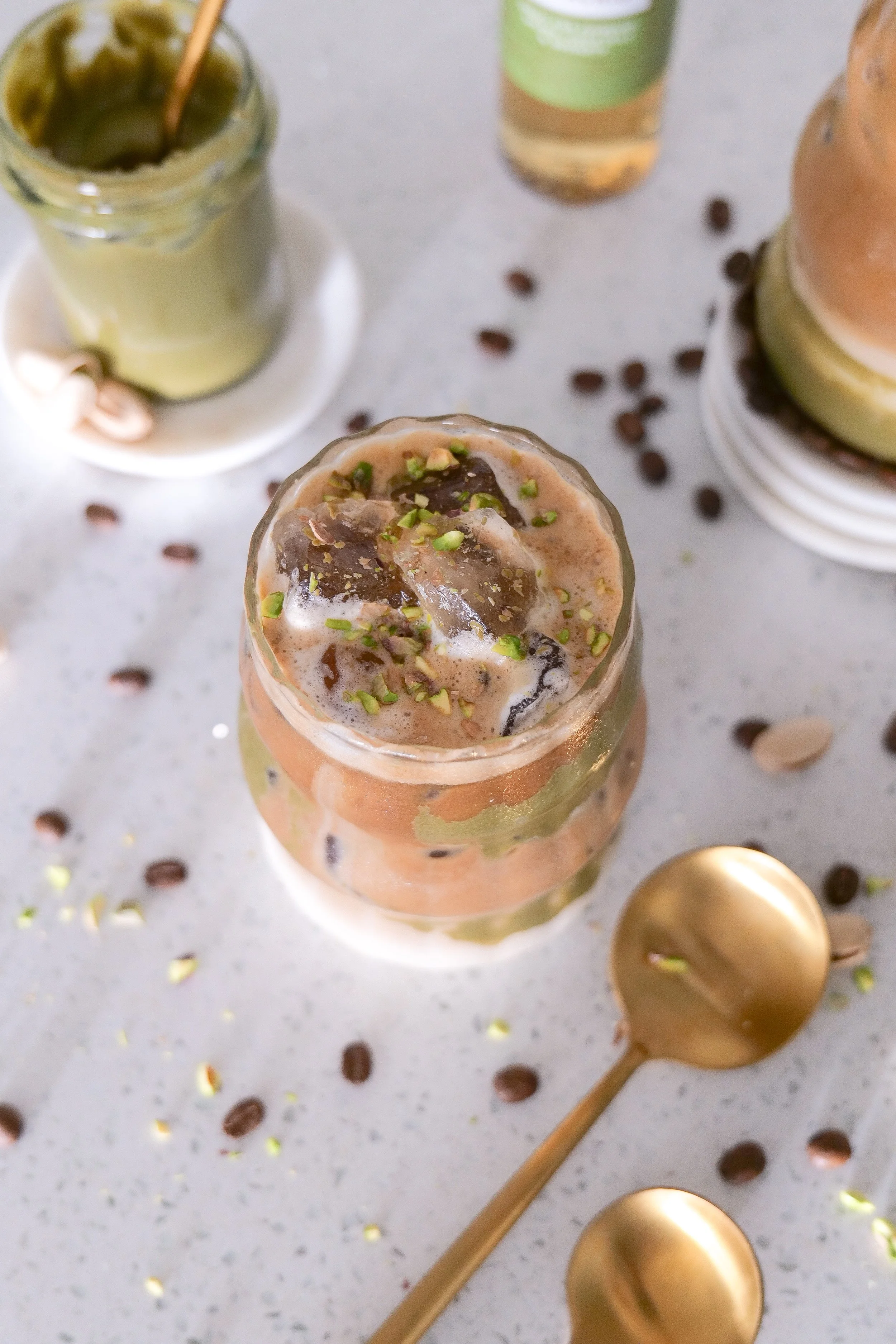 Iced pistachio latte garnished with crushed pistachios for a coffee shop–style finish.