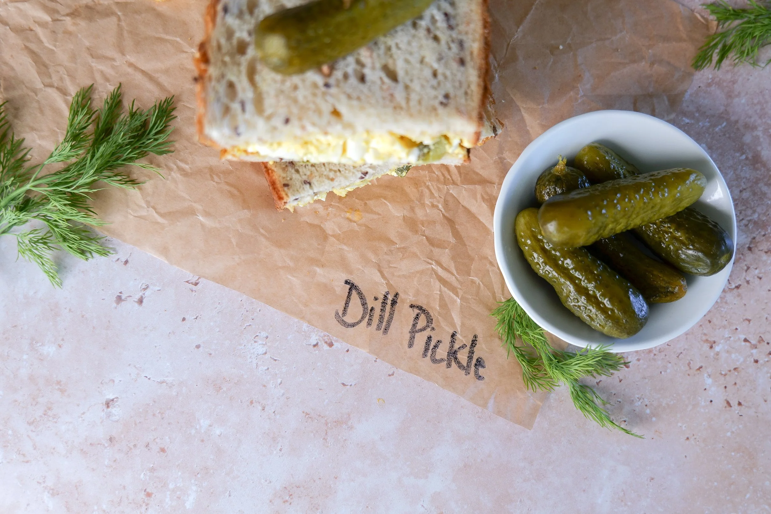 Creamy homemade egg salad mixed with finely chopped dill pickles and fresh herbs.
