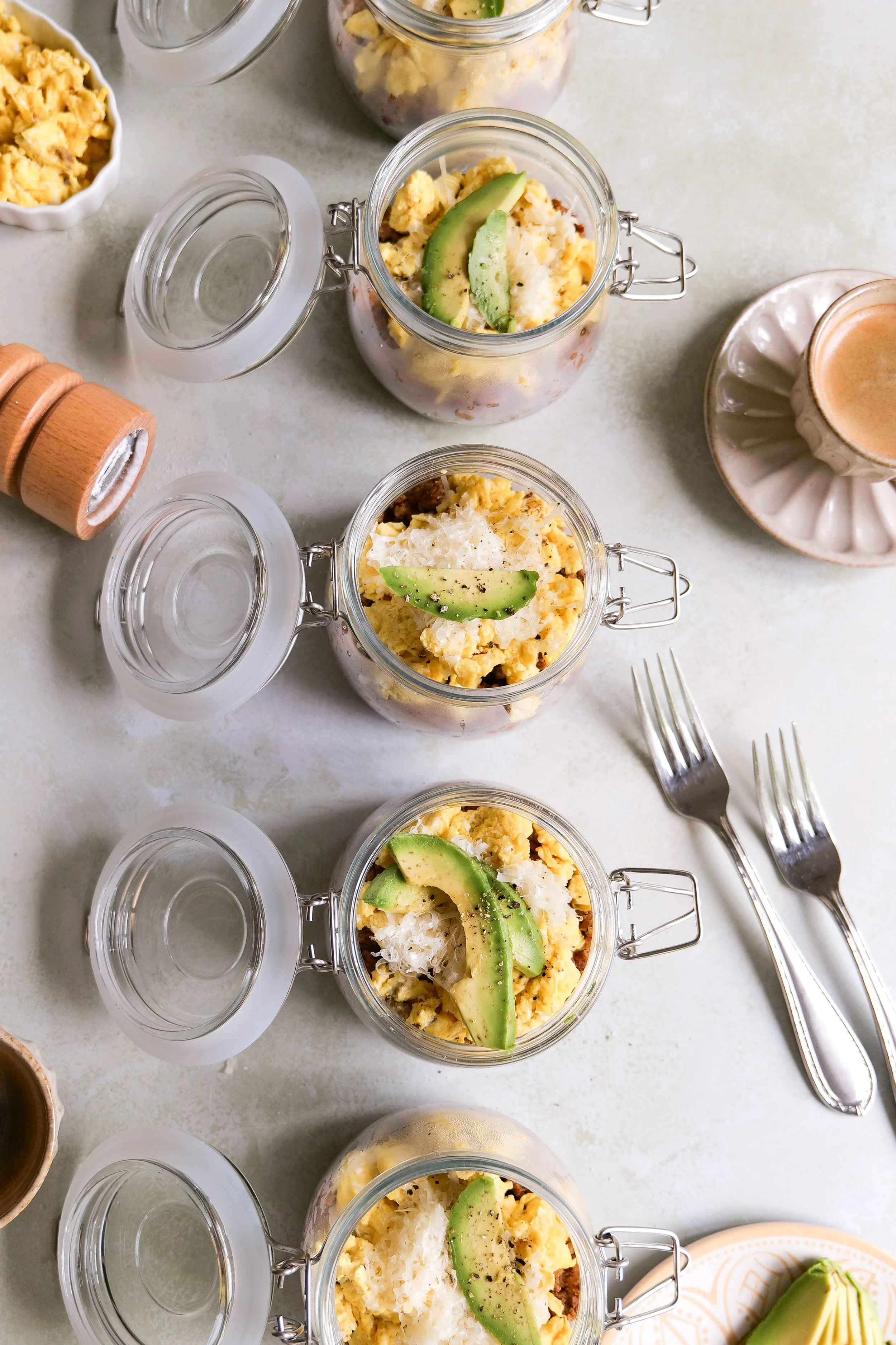 Chorizo, egg and crispy potato breakfast bowl topped with mozzarella cheese and sliced avocado.
