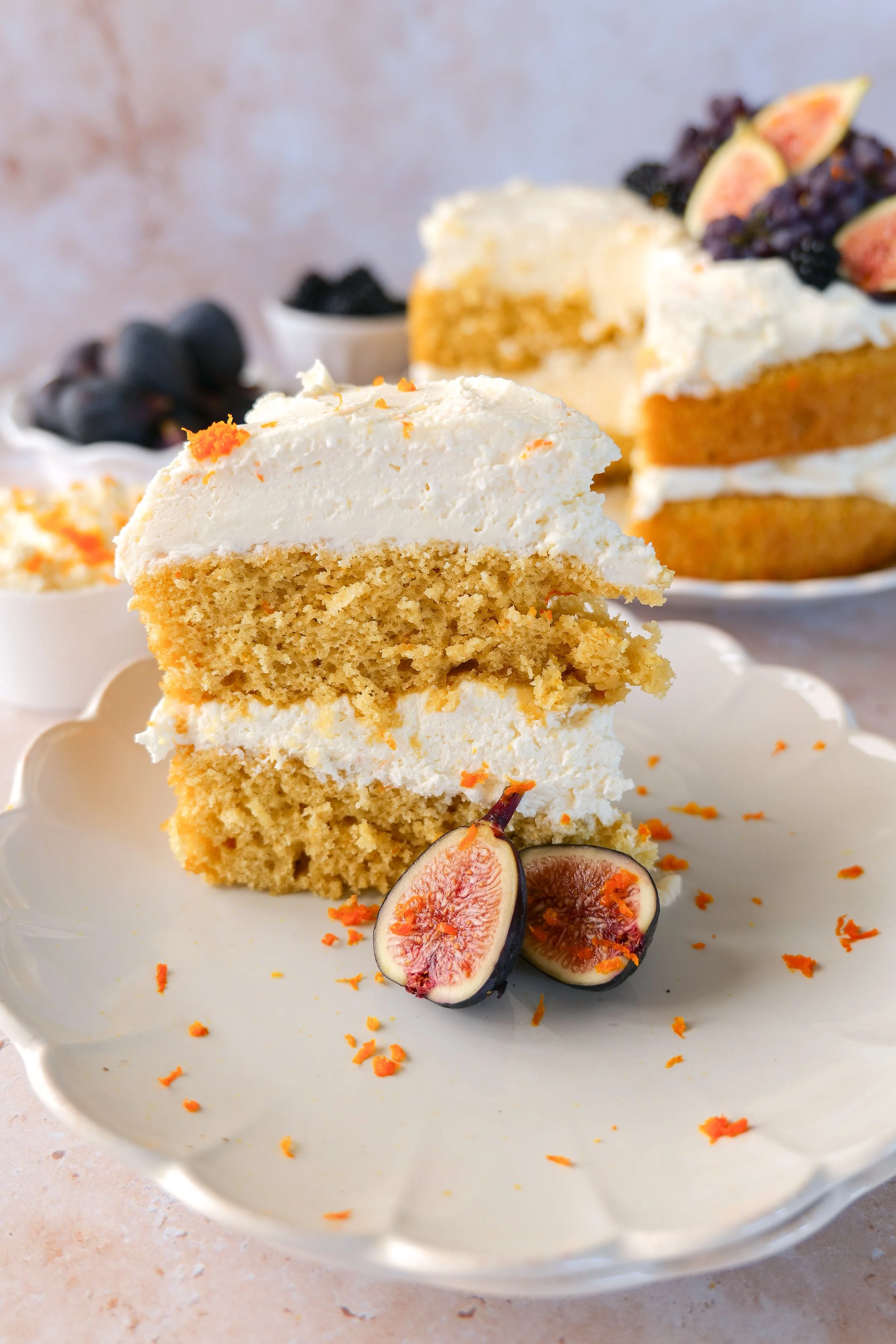 Slice of orange olive oil cake with mascarpone cream and fresh seasonal fruit