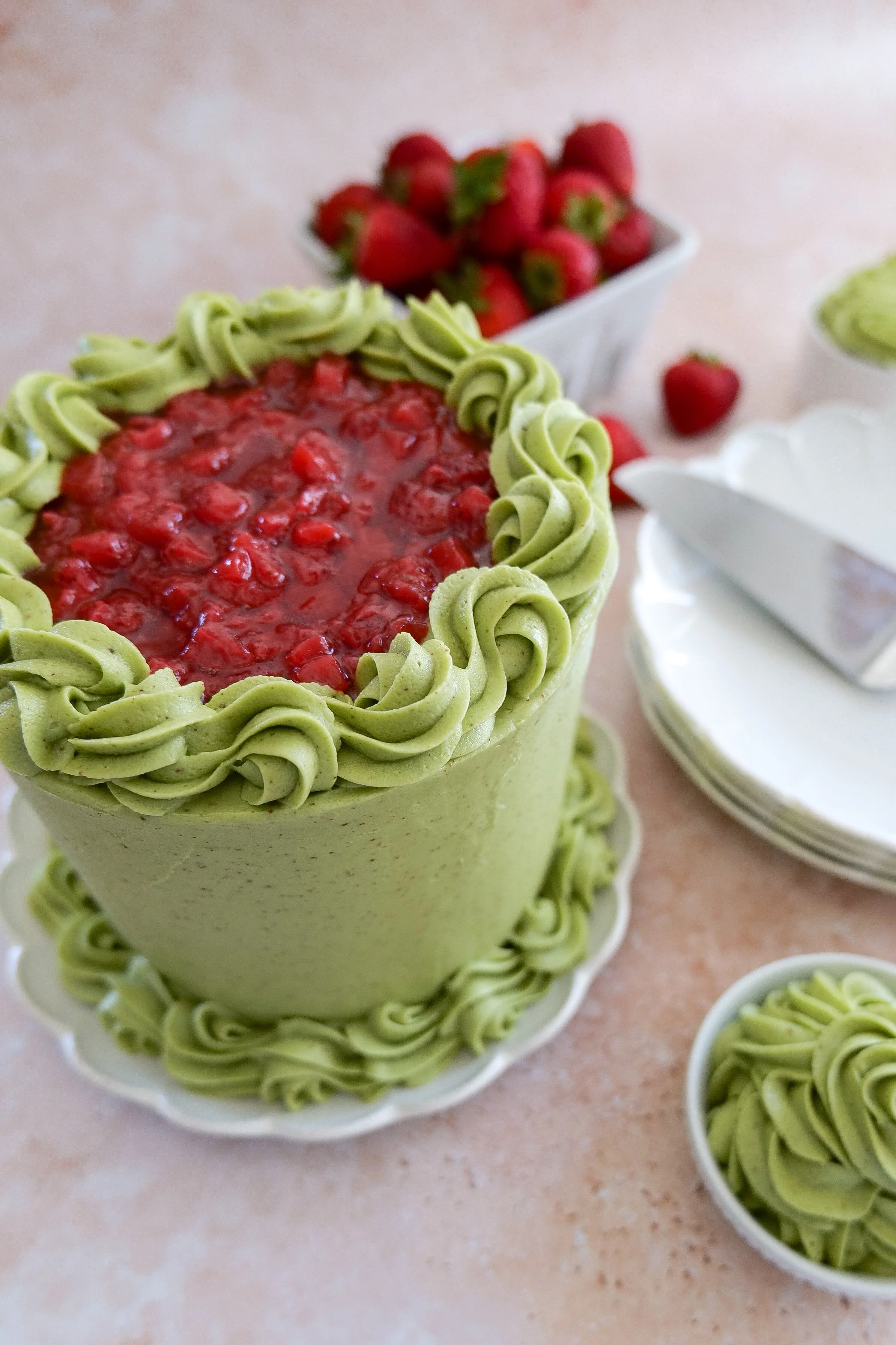 Homemade matcha strawberry cake with strawberry filling spread on top