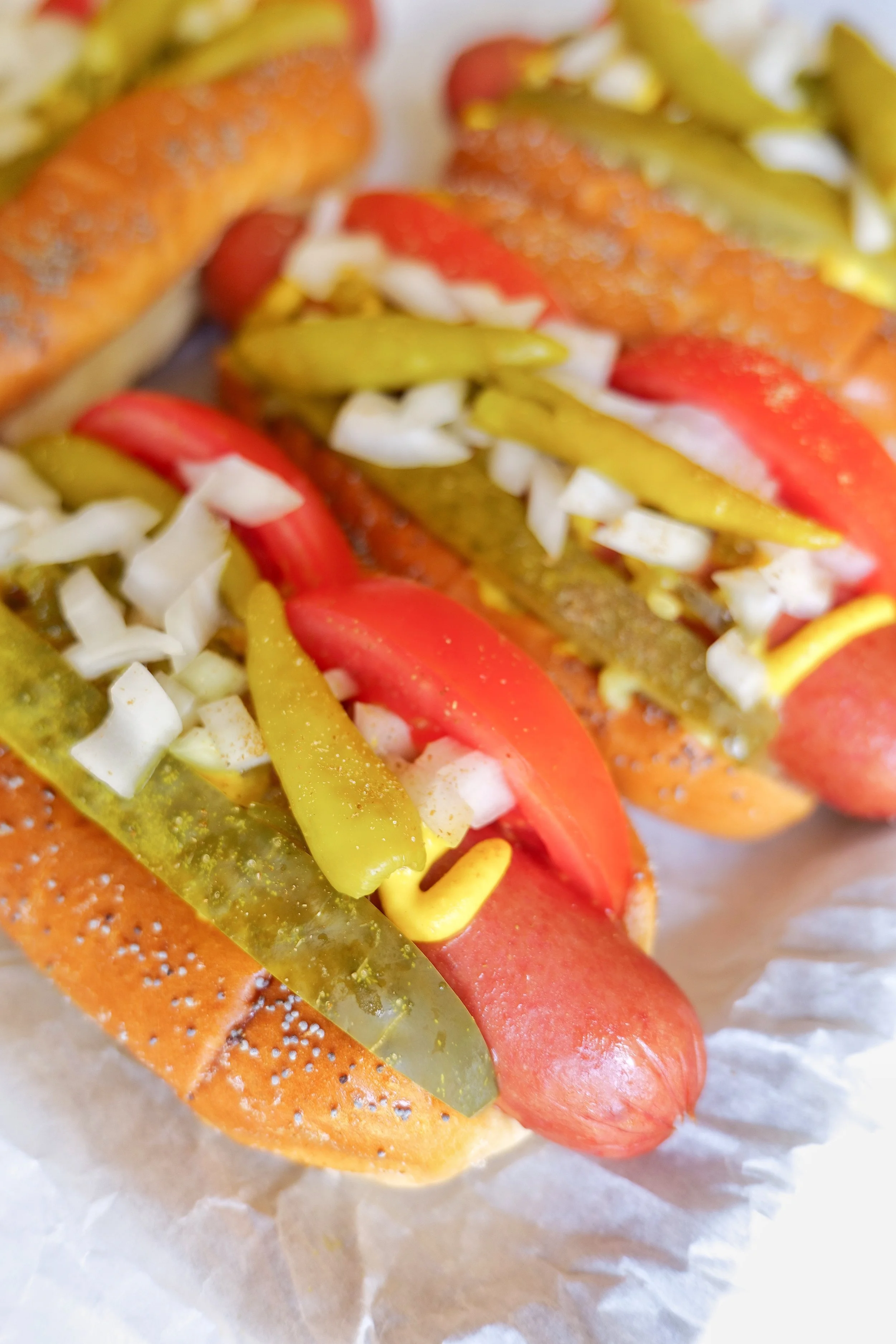 Summer cookout hot dogs styled on a serving tray with classic Chicago toppings.