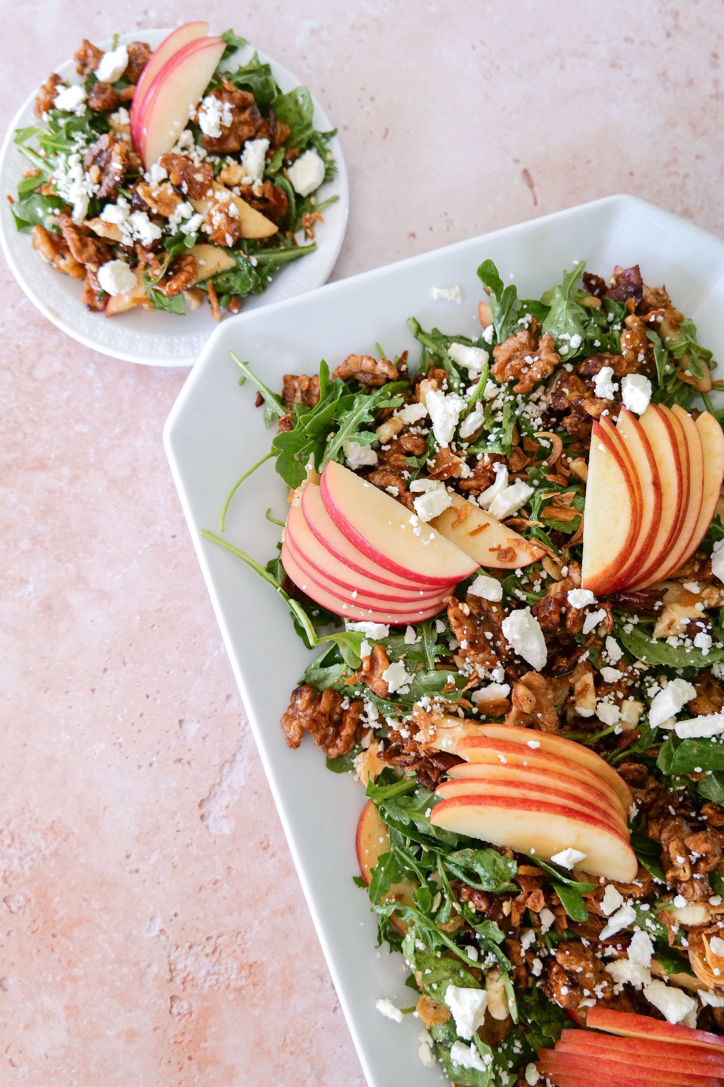 Maple bacon apple fall salad topped with feta, maple walnuts and crispy shallots over fresh mixed greens.