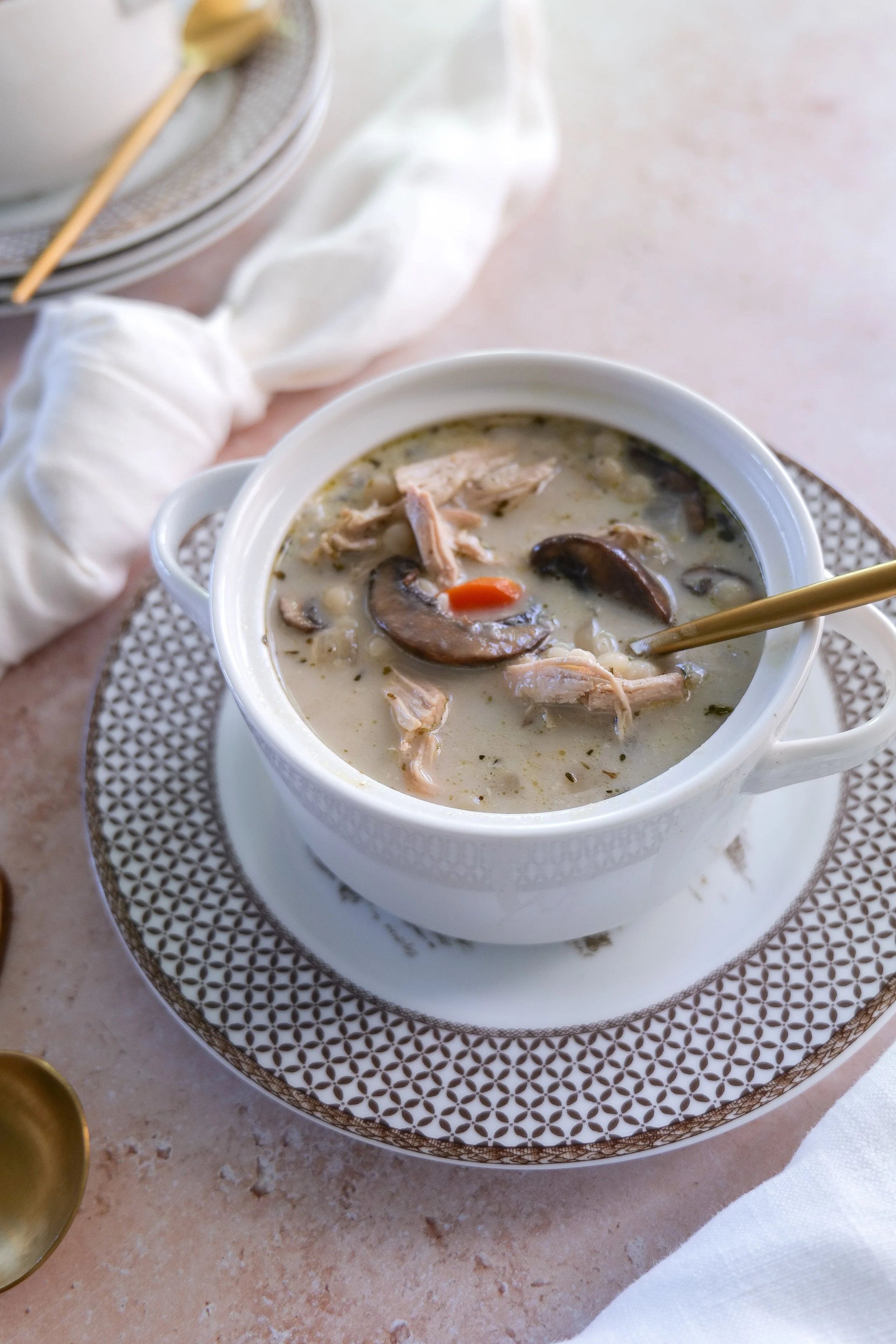 Slow cooker chicken couscous soup with mushrooms, carrots and a rich creamy broth.