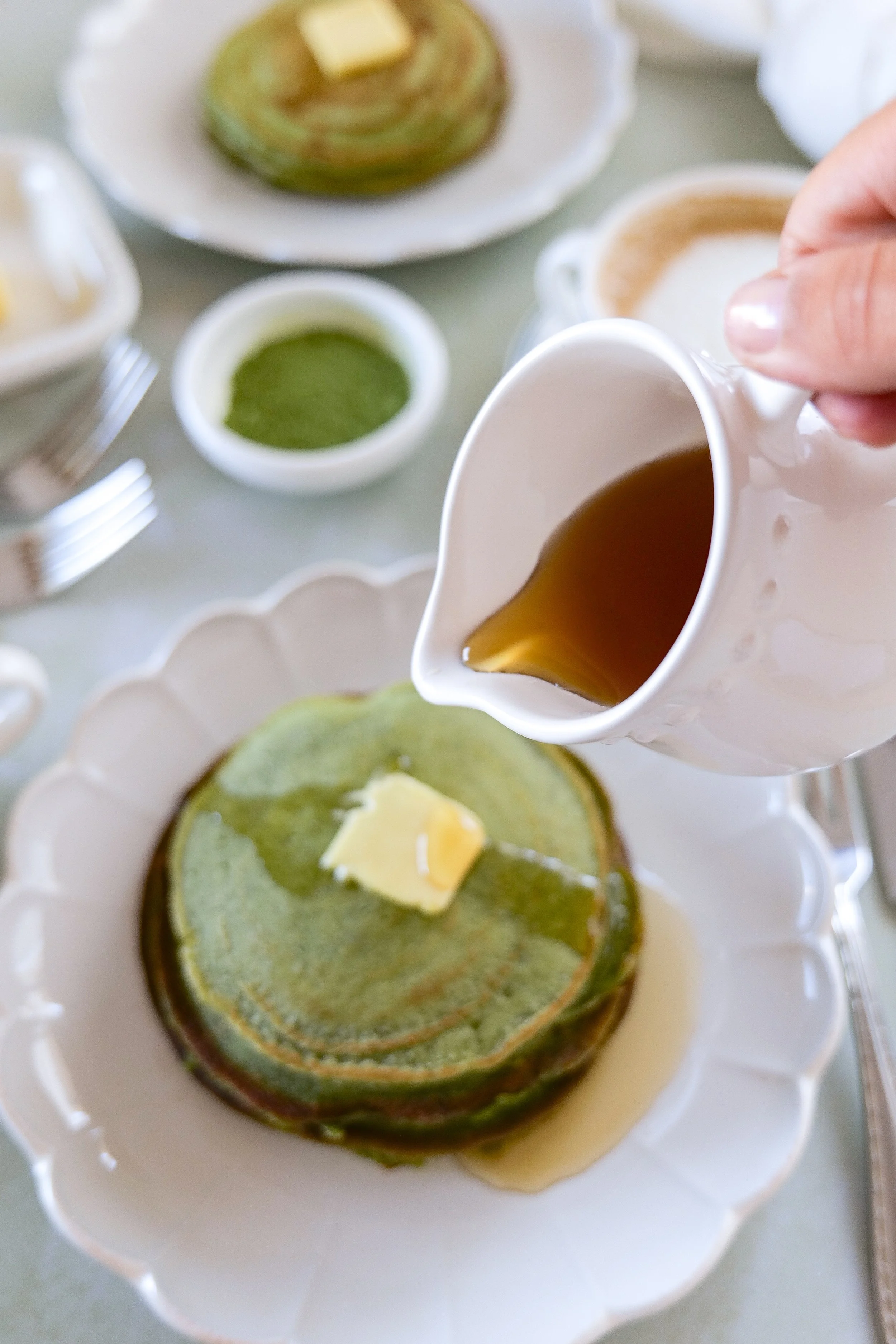 Matcha sourdough discard pancakes with butter and maple syrup topping