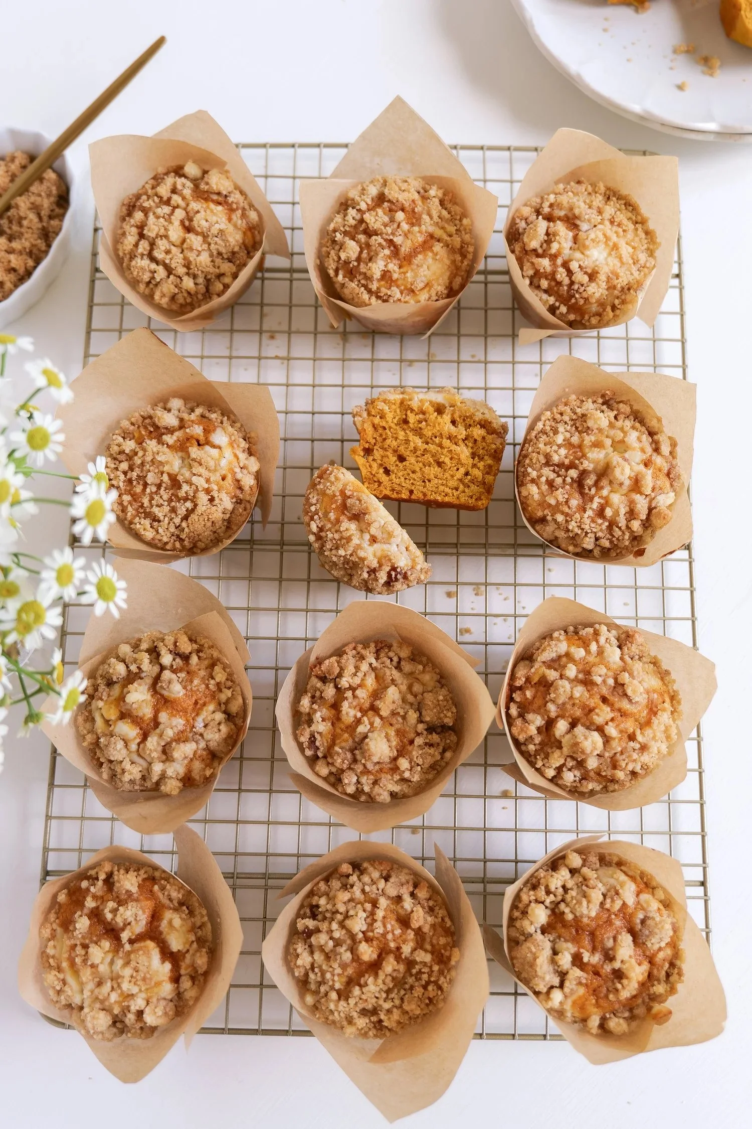 Pumpkin cream cheese muffins with creamy centers and buttery streusel topping.
