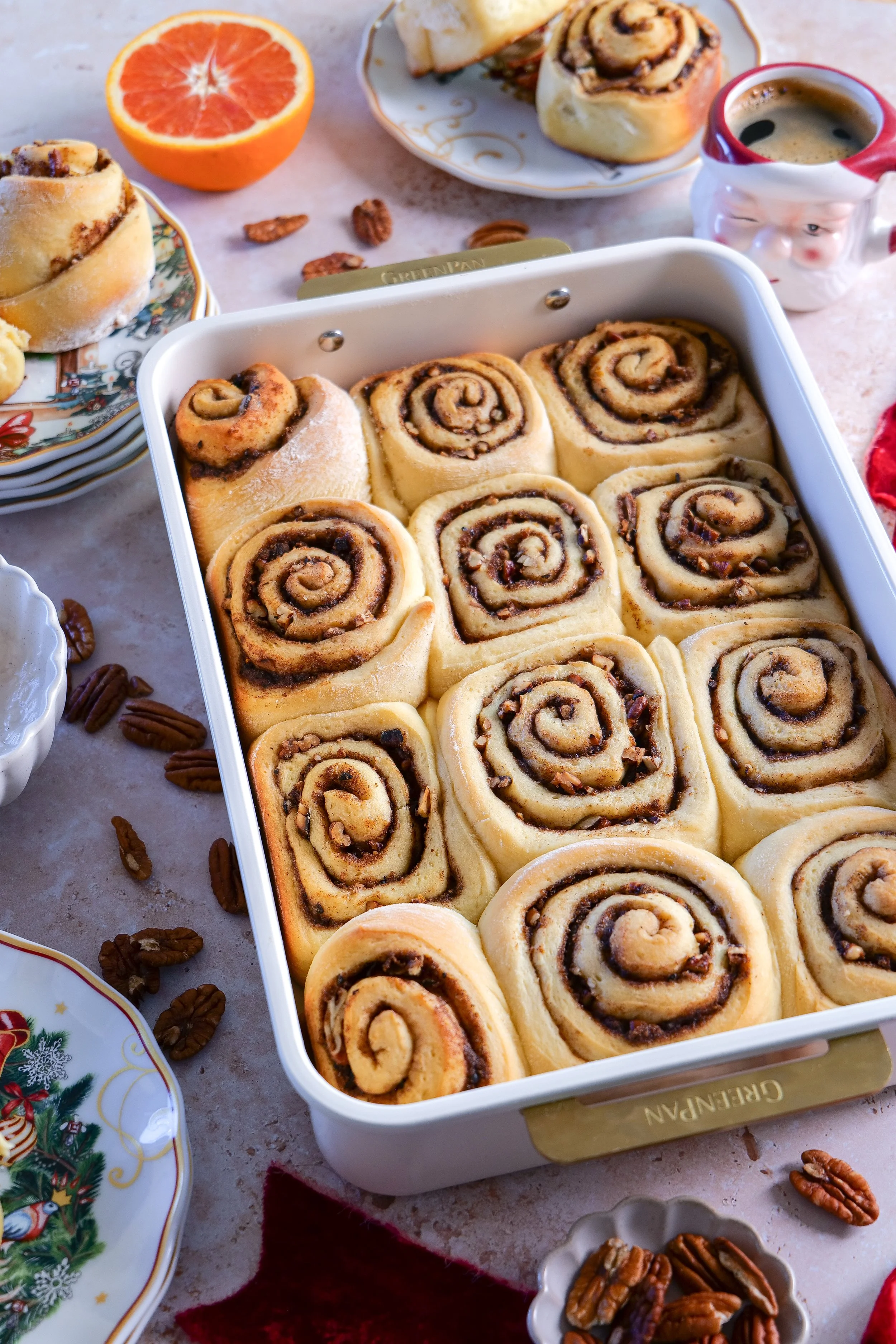 Golden brown homemade orange pecan cinnamon rolls fresh from the oven before glazing.