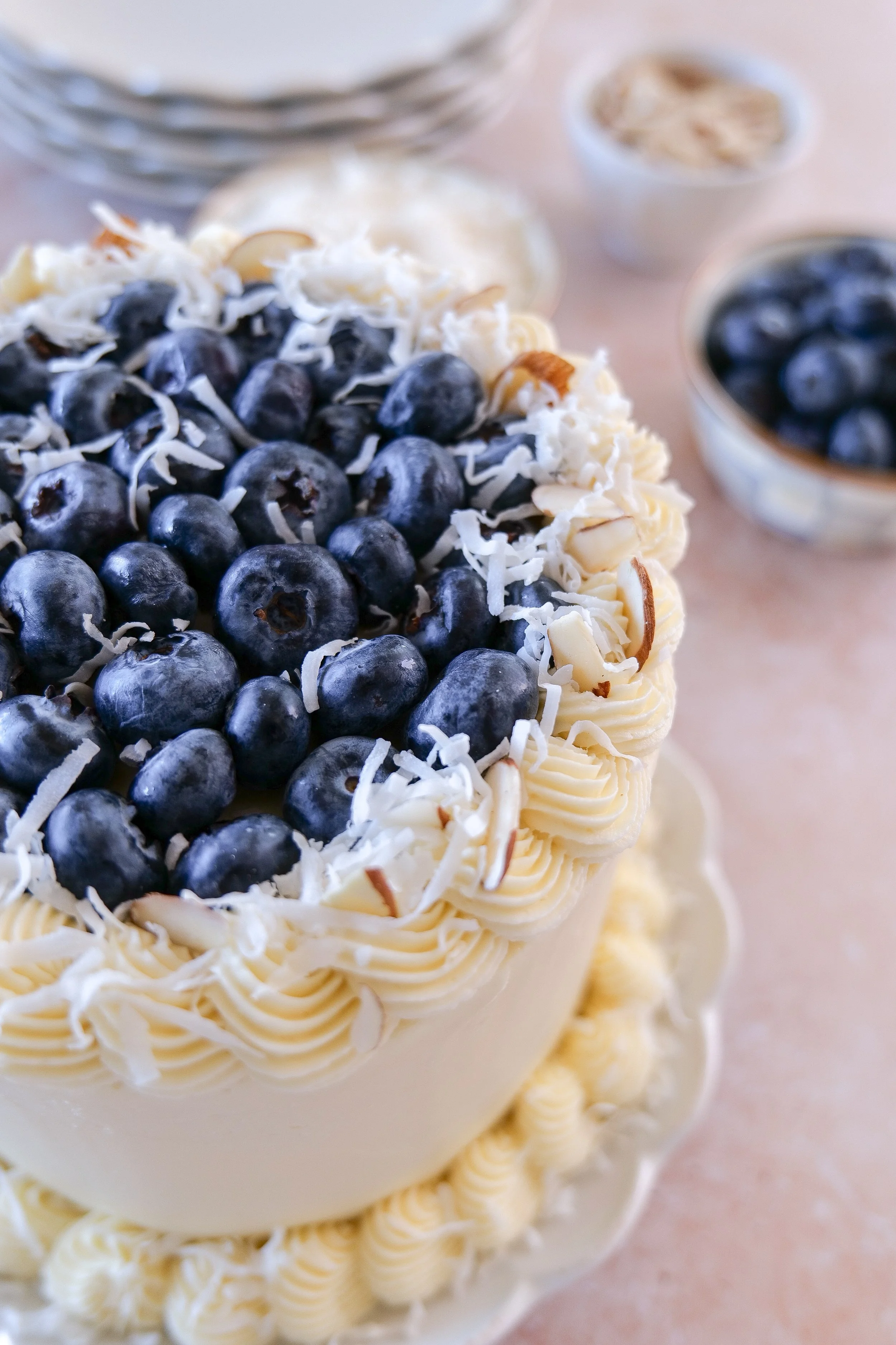 Bakery-style almond cake with blueberry curd and coconut frosting.