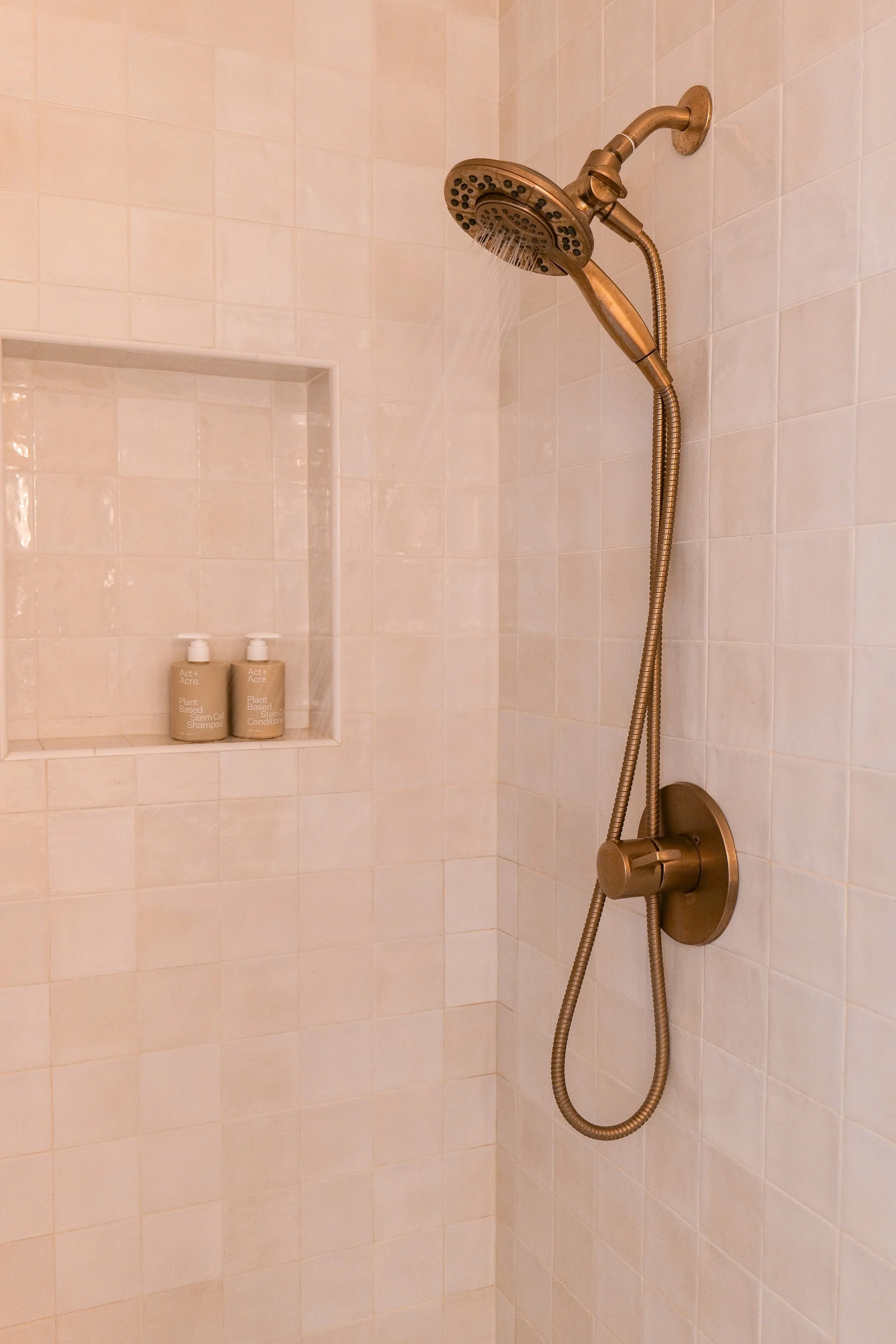 Detail of the shower faucet against the tile in our small bathroom remodel.