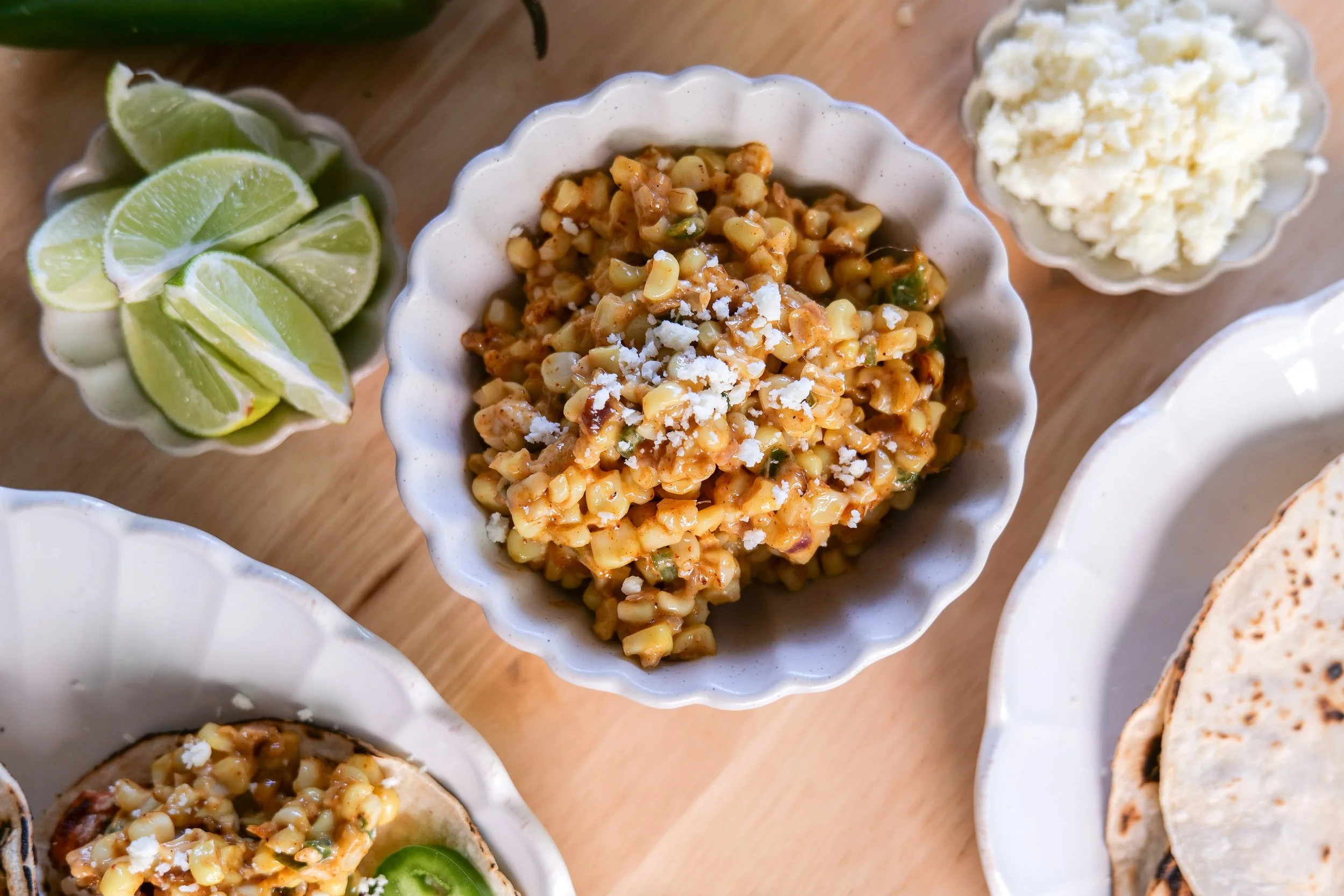 Creamy corn salsa with cotija cheese, red onion, jalapeño, and lime