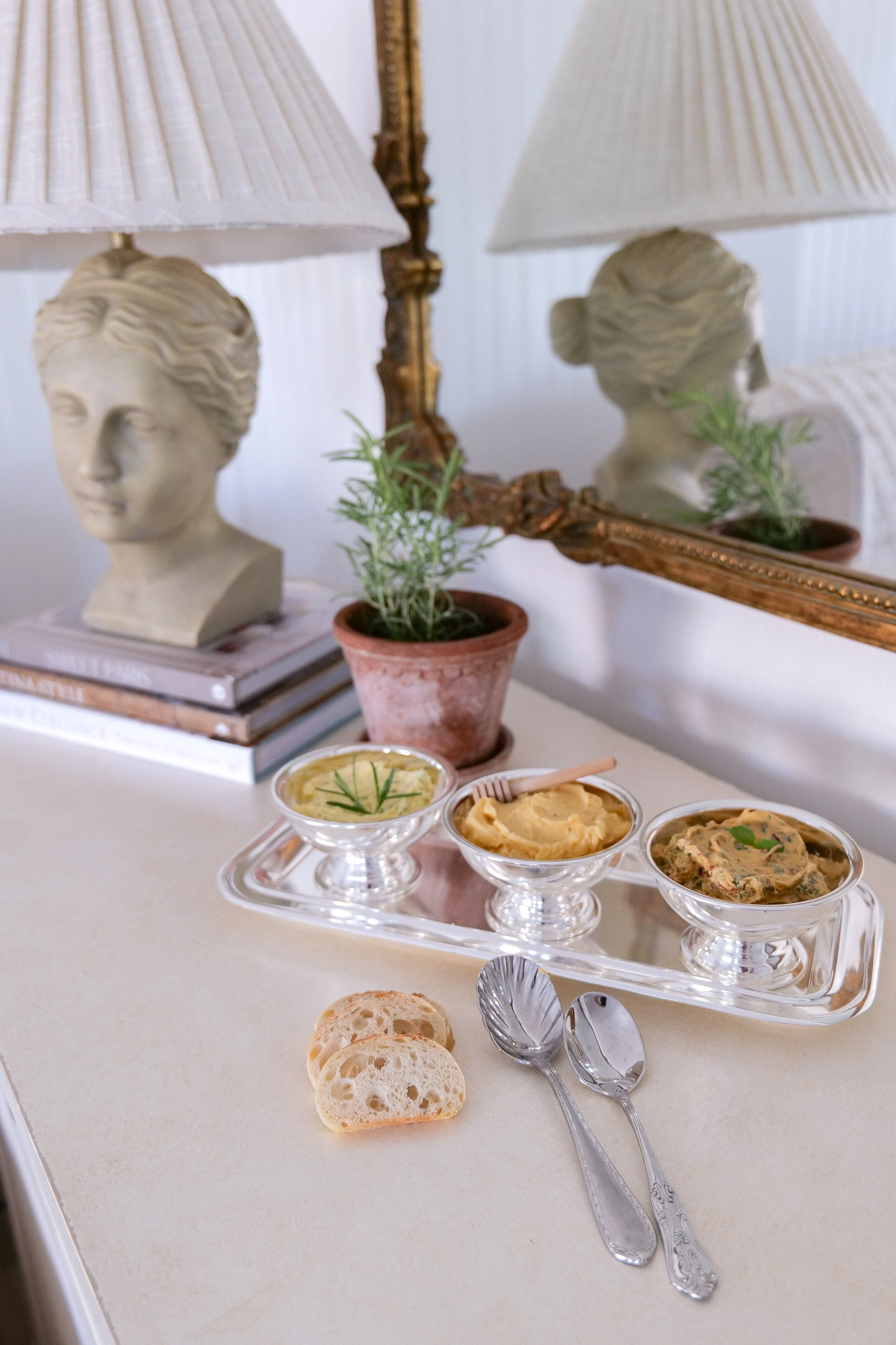 Trio of flavored butter including herb, honey, and lemon in metal cup