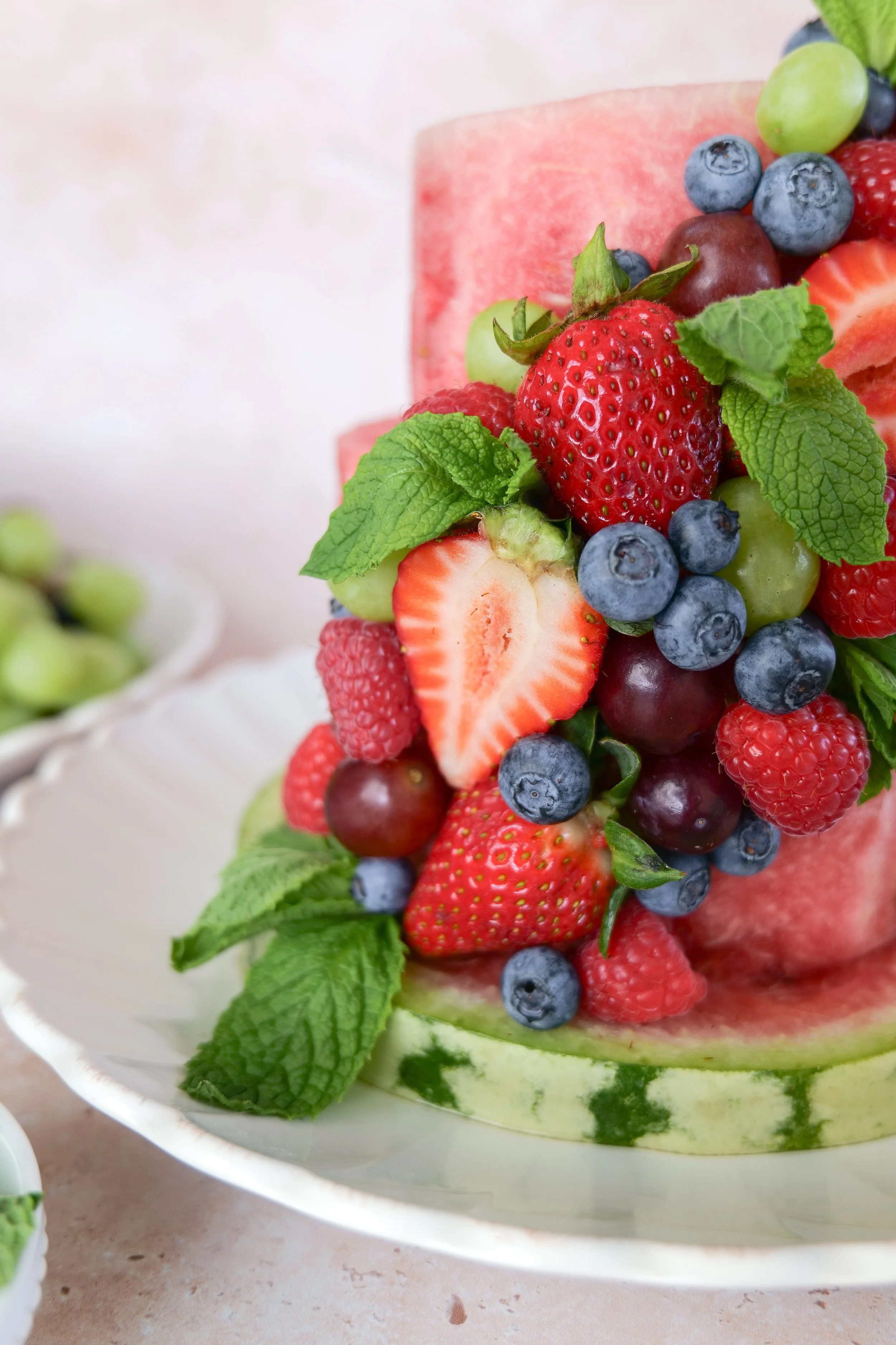 Fresh watermelon cake covered with colorful summer fruit for a birthday, baby milestone, or warm-weather celebration.