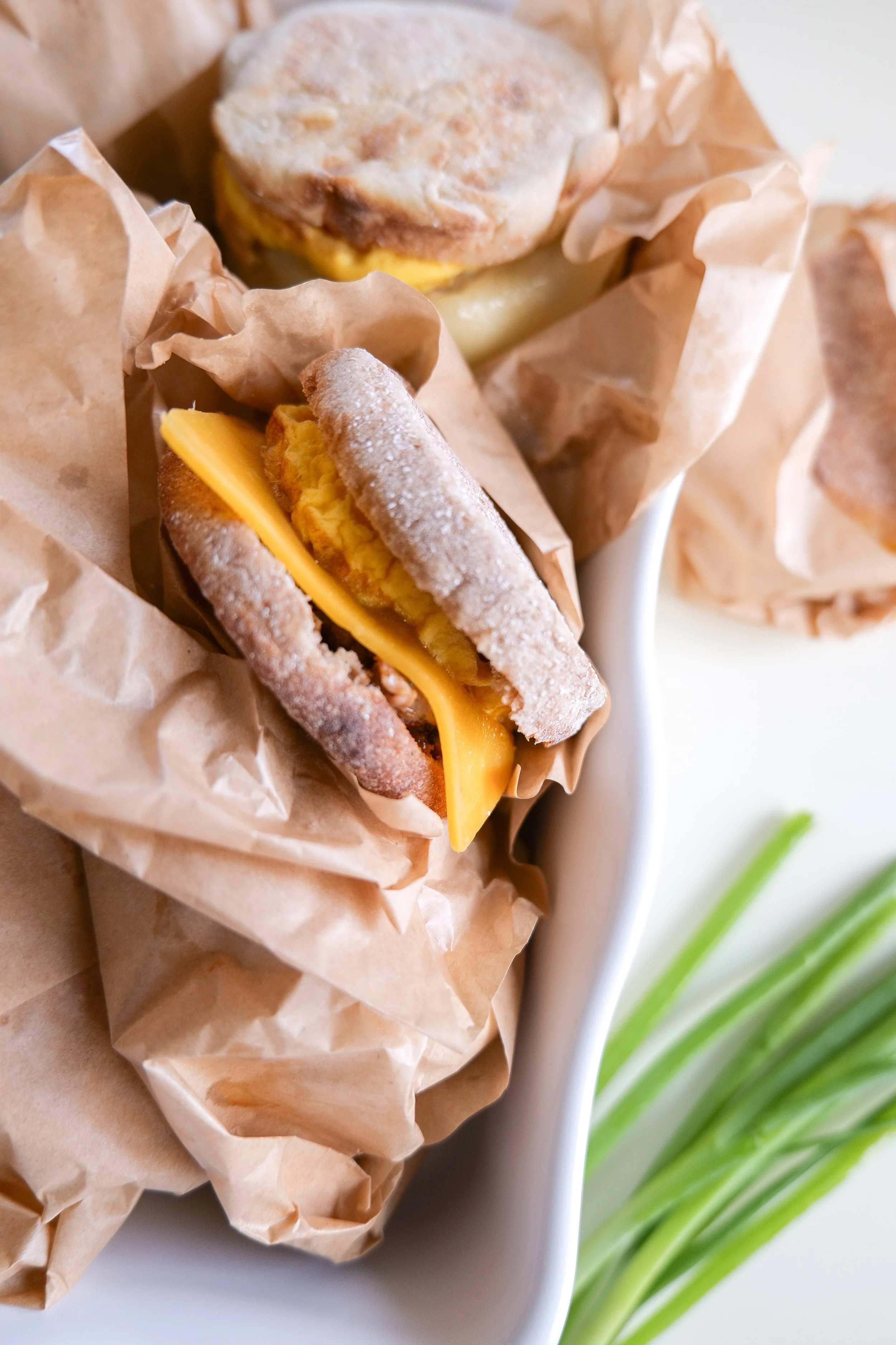 Make-ahead sausage breakfast sandwich with egg and cheese on a toasted English muffin.