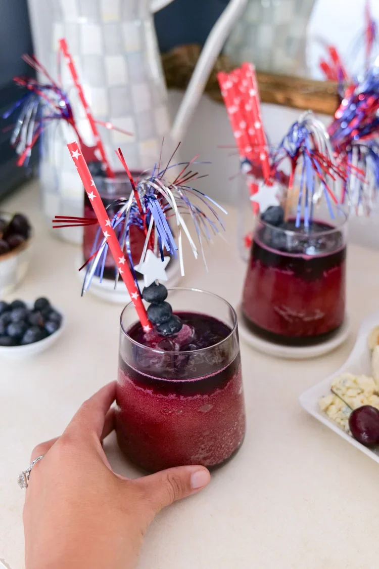 Frozen cherry berry slushie topped with homemade blueberry syrup