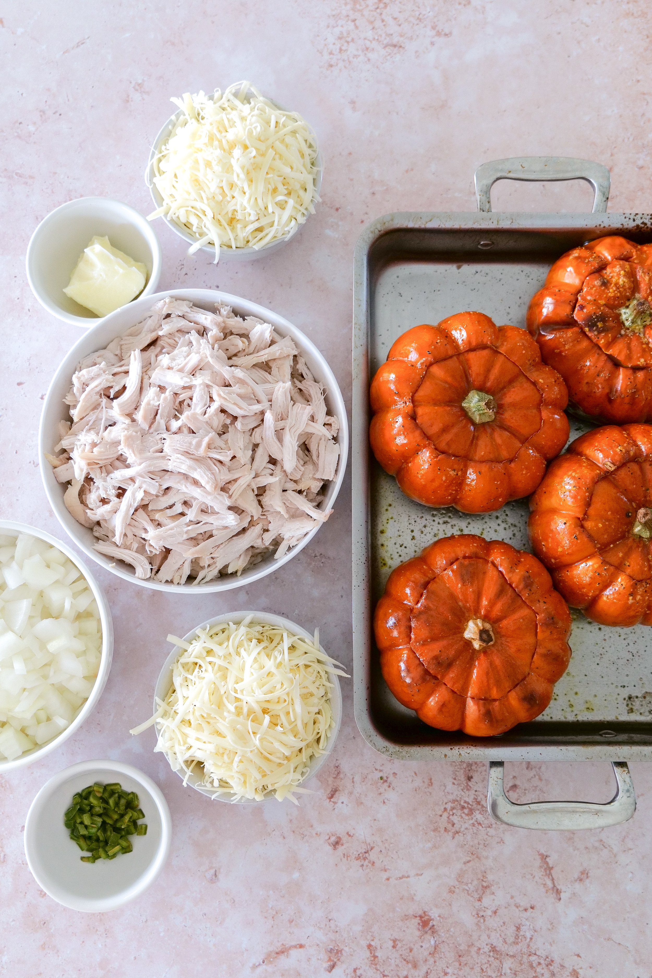 Ingredients for creamy chicken stuffed pumpkins with baby pumpkins, chicken, Gruyère cheese and walnuts.