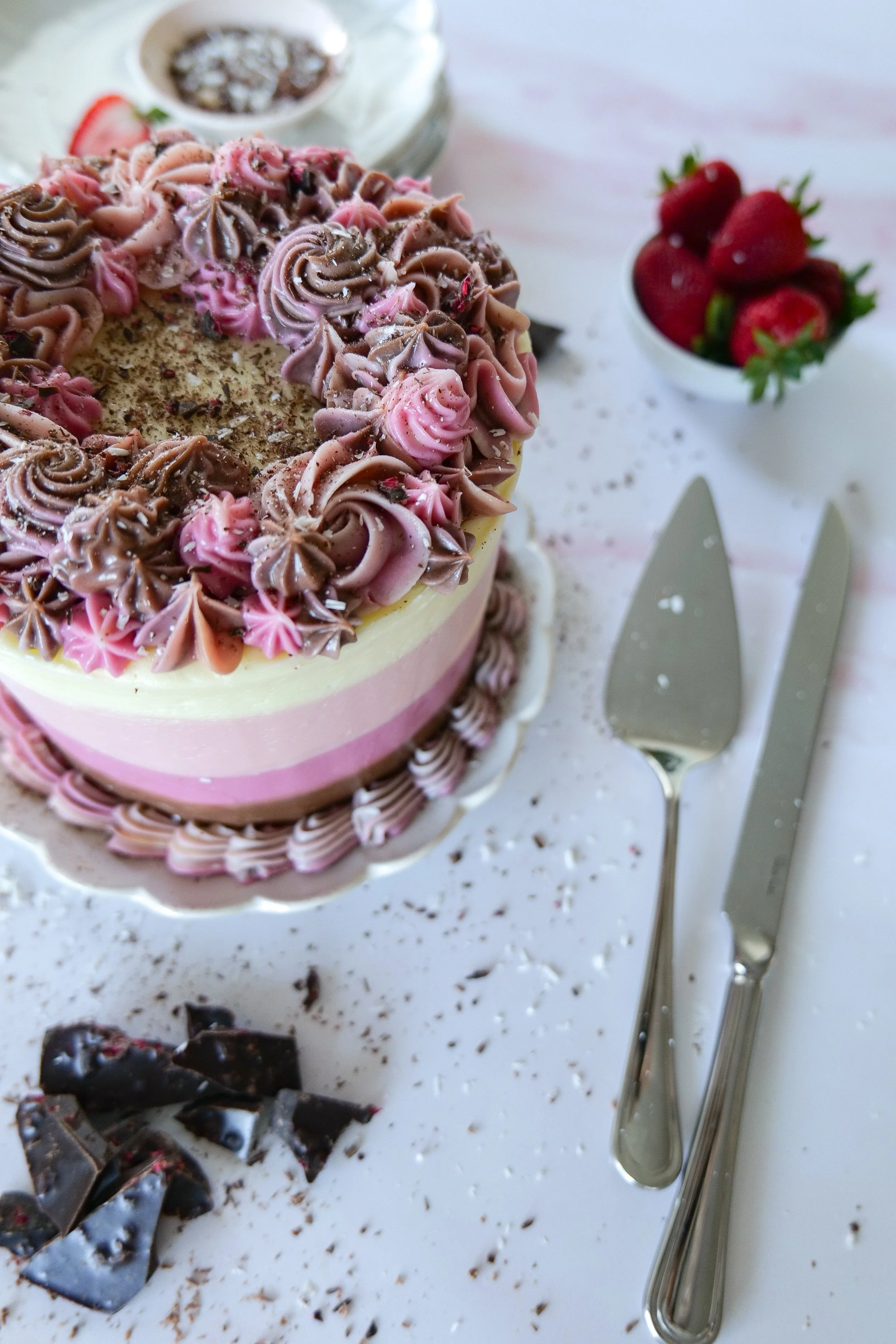 Classic Neapolitan cake inspired by chocolate, vanilla, and strawberry ice cream flavors.