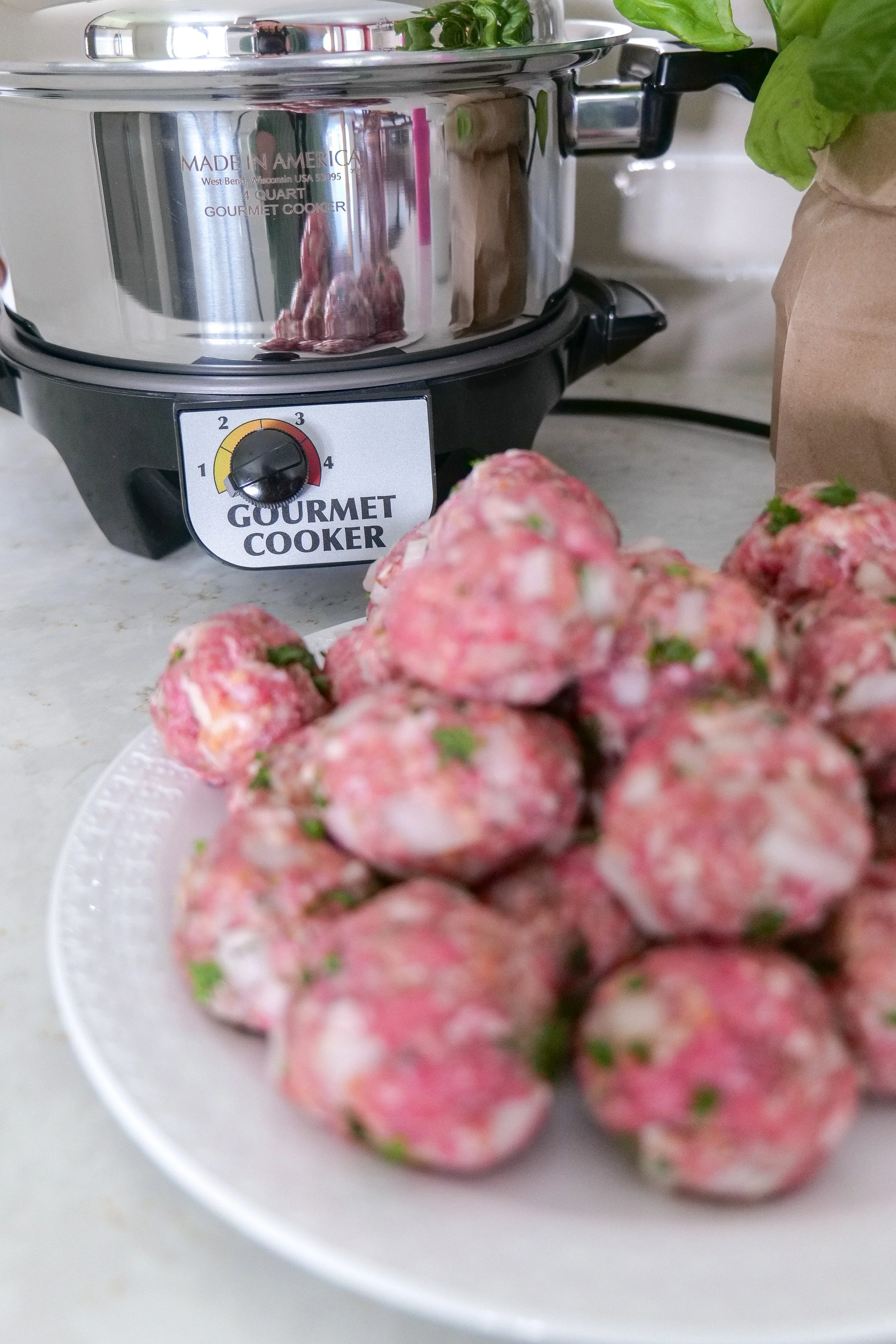 Easy slow cooker meatball recipe cooking in a crockpot with rich tomato sauce
