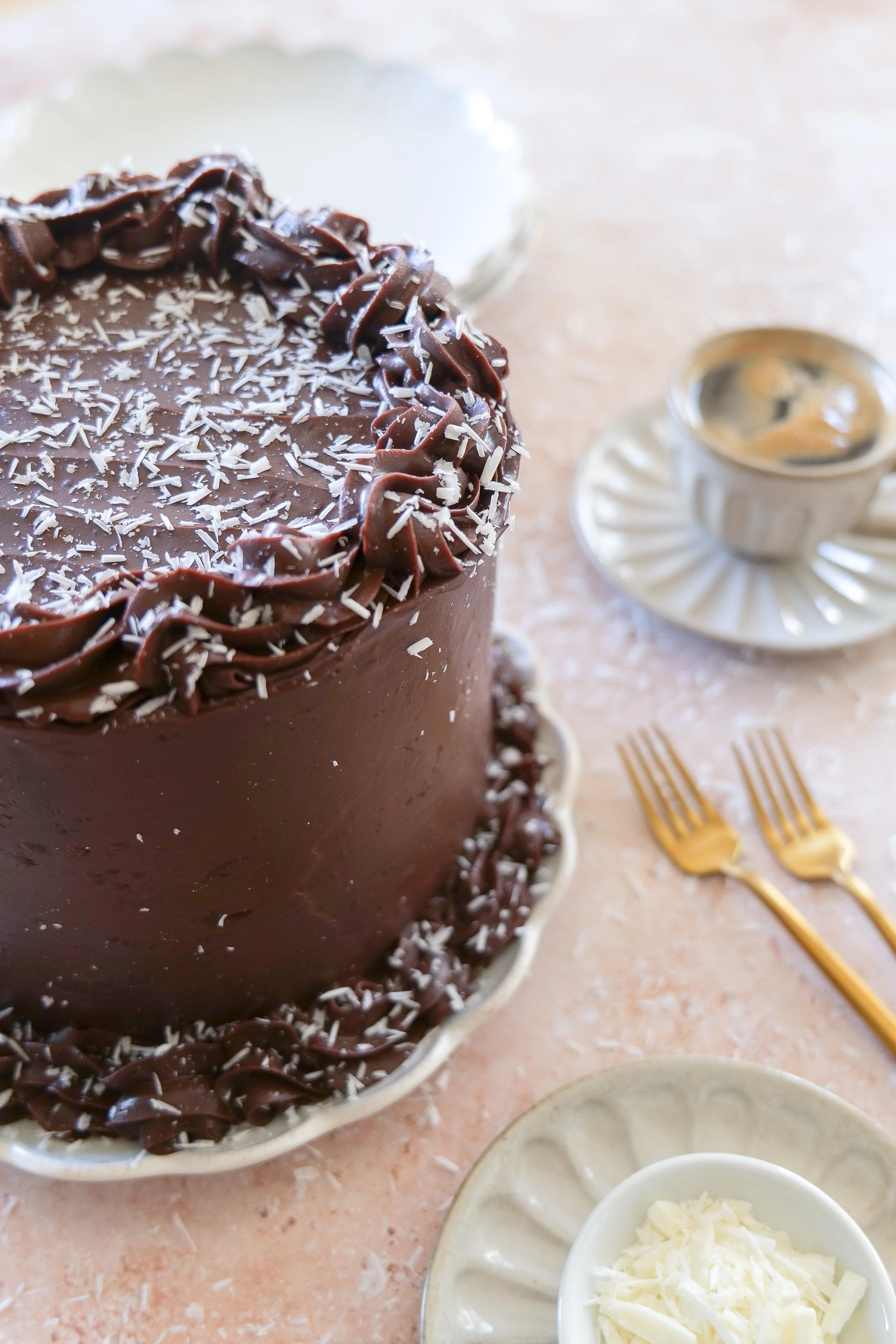 Decadent homemade chocolate layer cake covered in silky milk chocolate ganache.