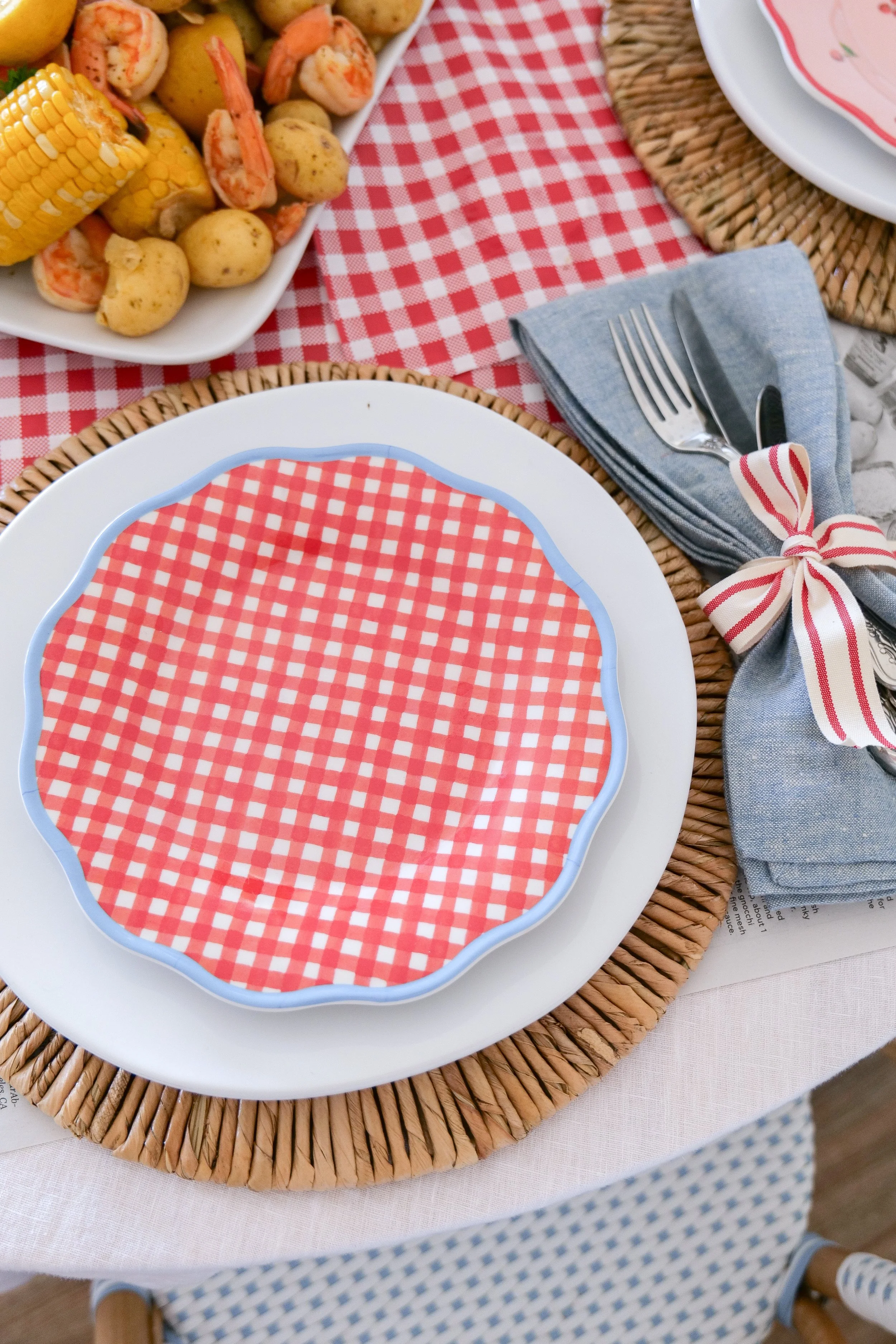 Patriotic shrimp boil tablescape styled for summer entertaining.