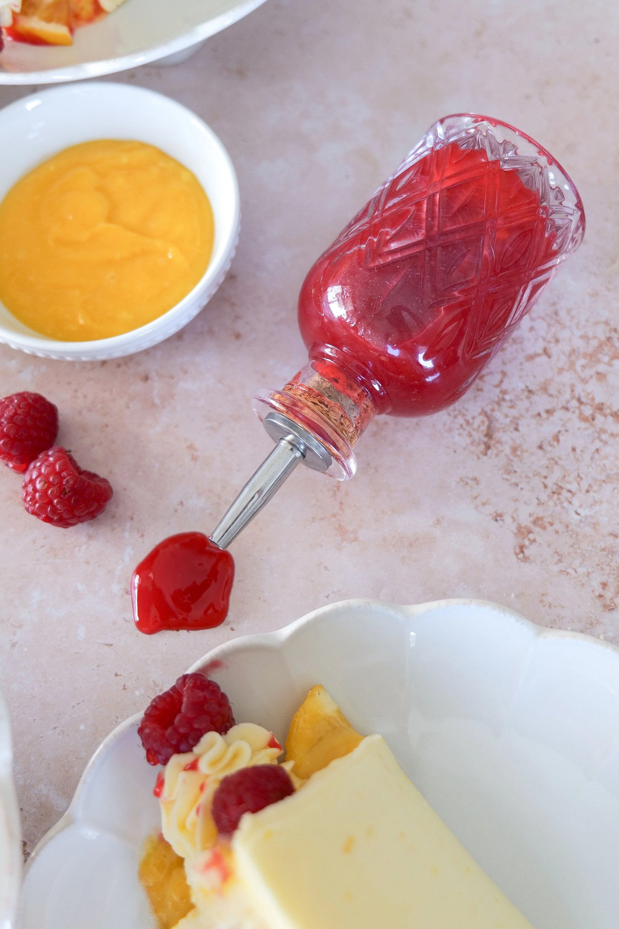 Raspberry lemon layer cake filled with lemon curd and fresh berries.