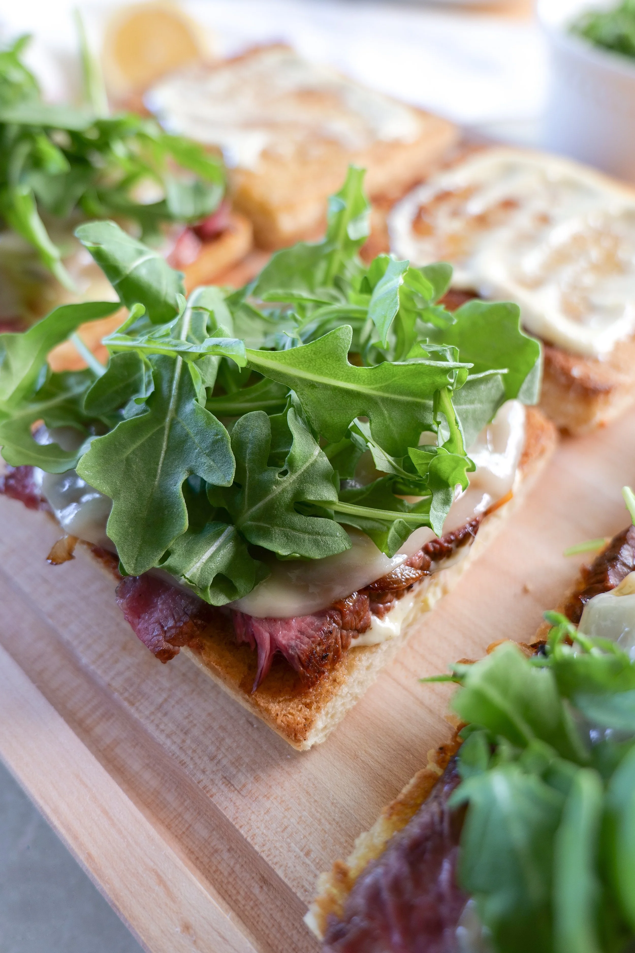 Steak focaccia sandwich with arugula and garlic aioli