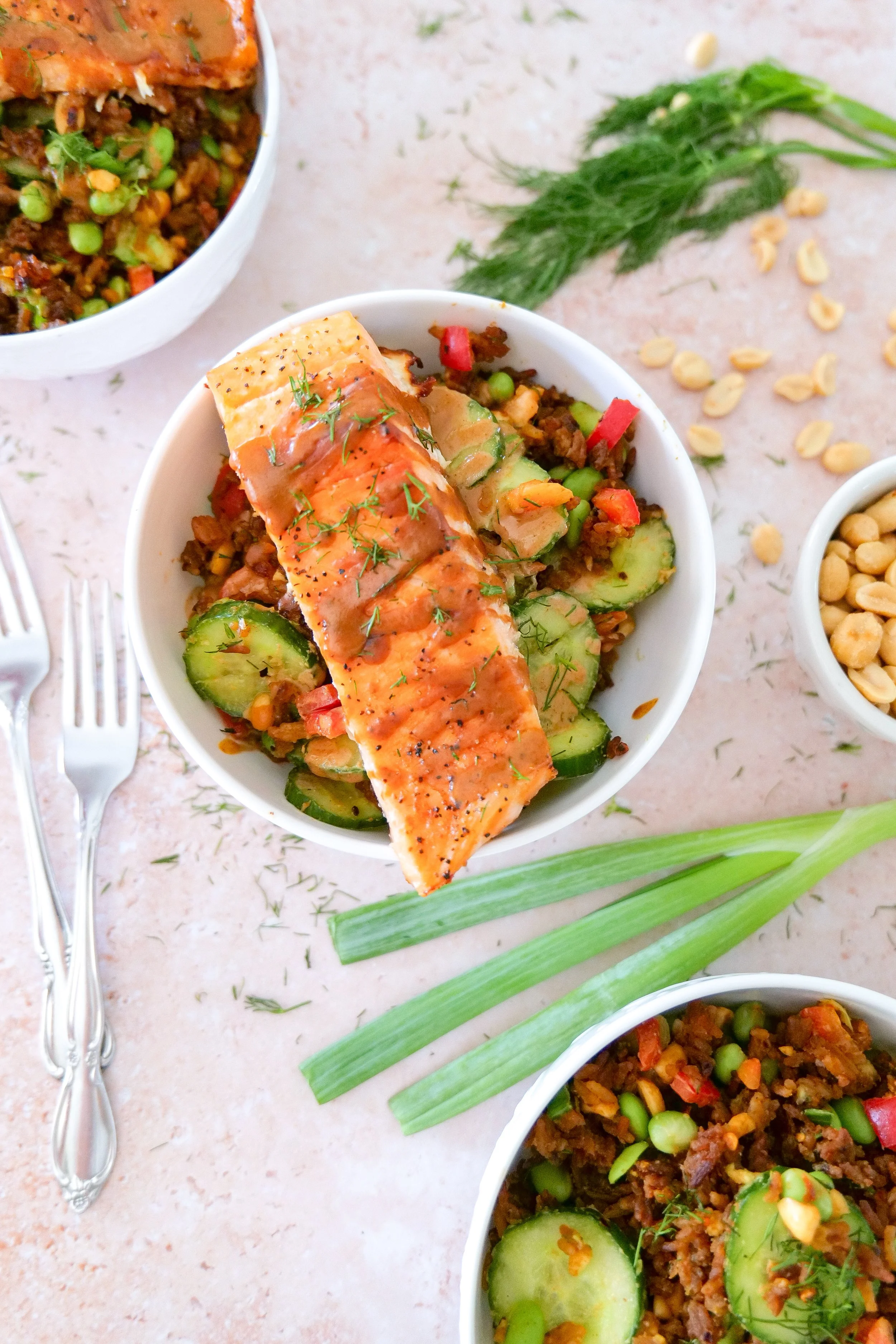 Crispy rice salmon dinner with fresh avocado, cucumber, edamame and red bell pepper.