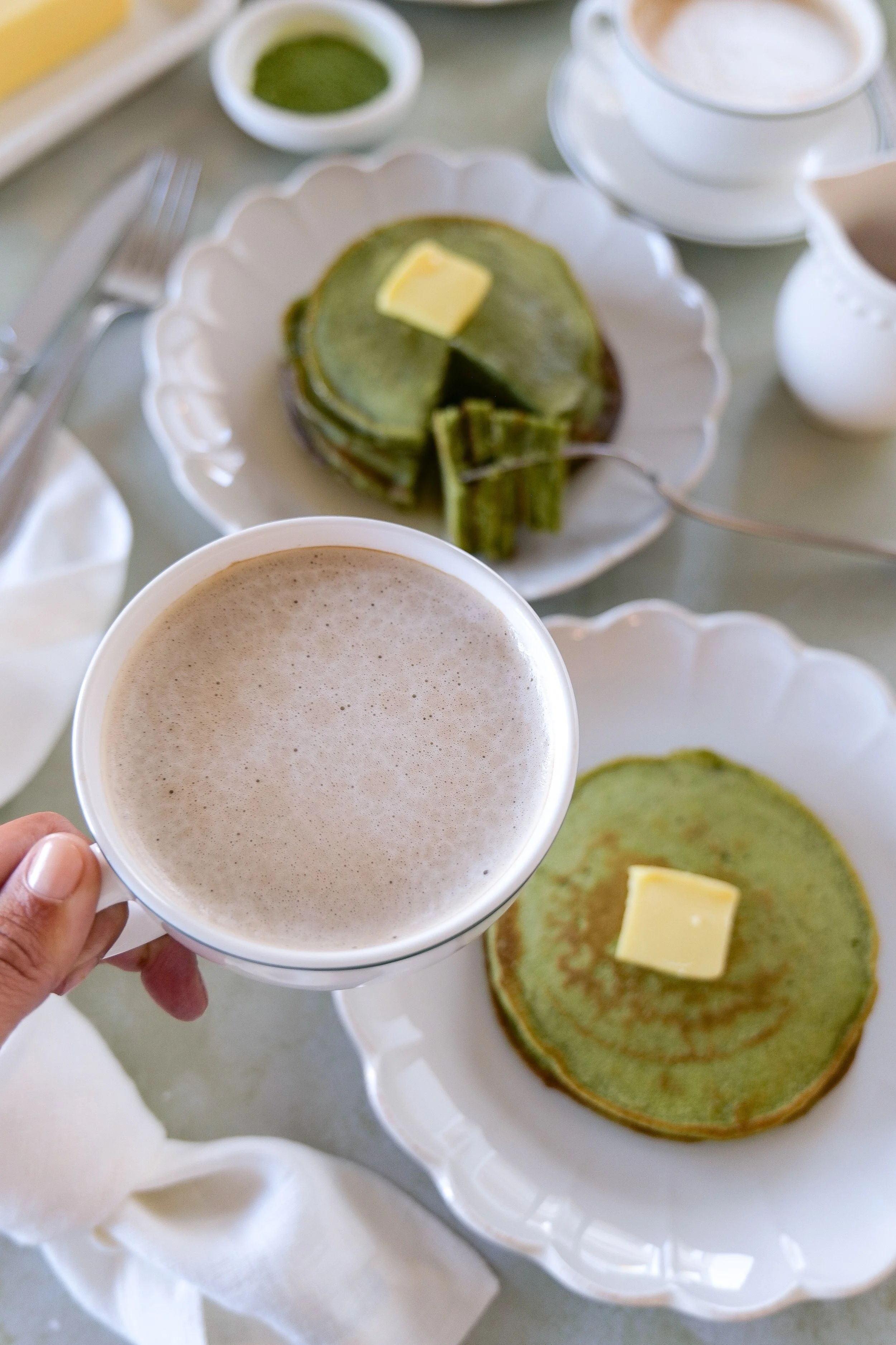a cup of coffee and a matcha sourdough discard pancakes