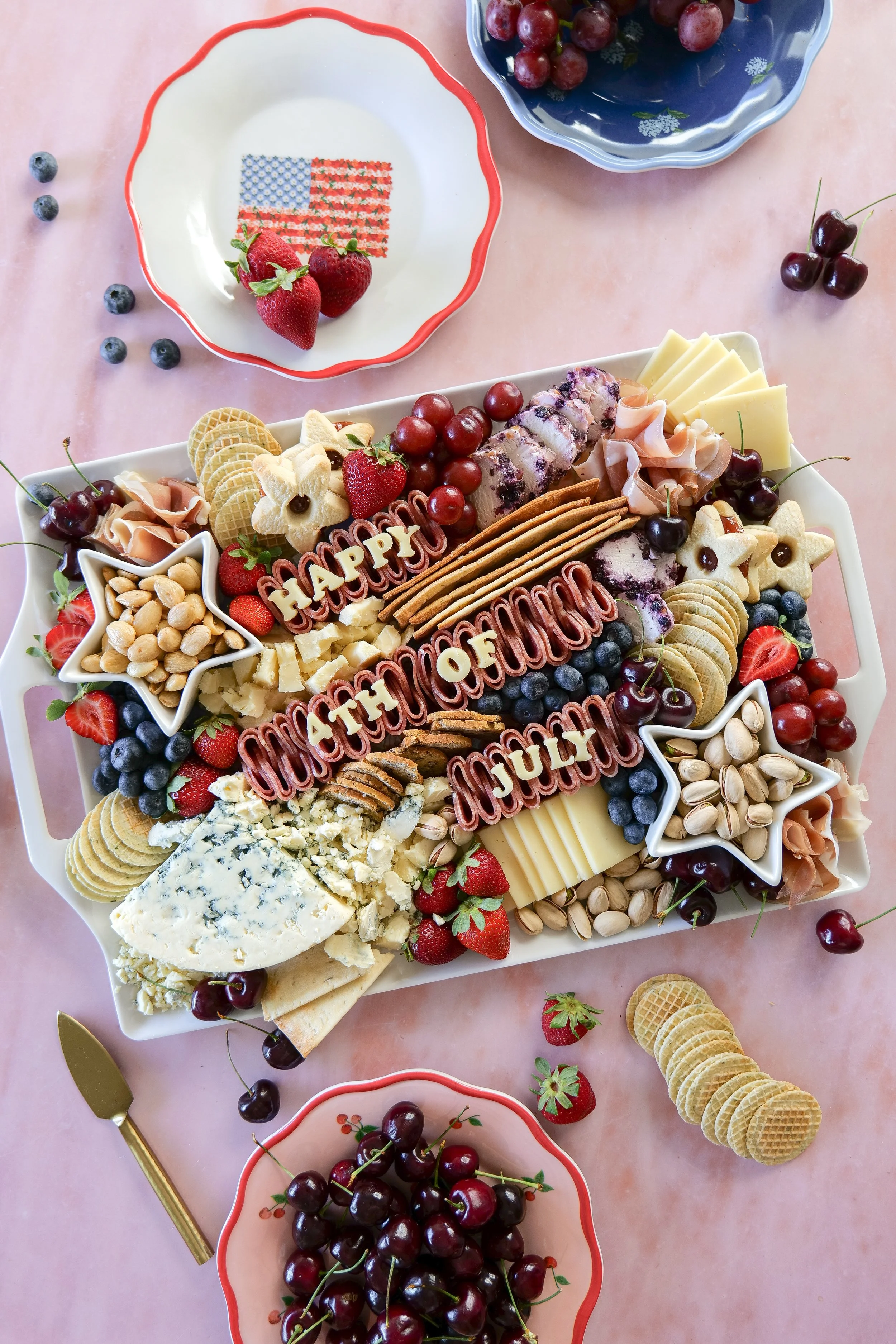 Close-up of an All-American charcuterie board with cheese, fruit, and festive details.