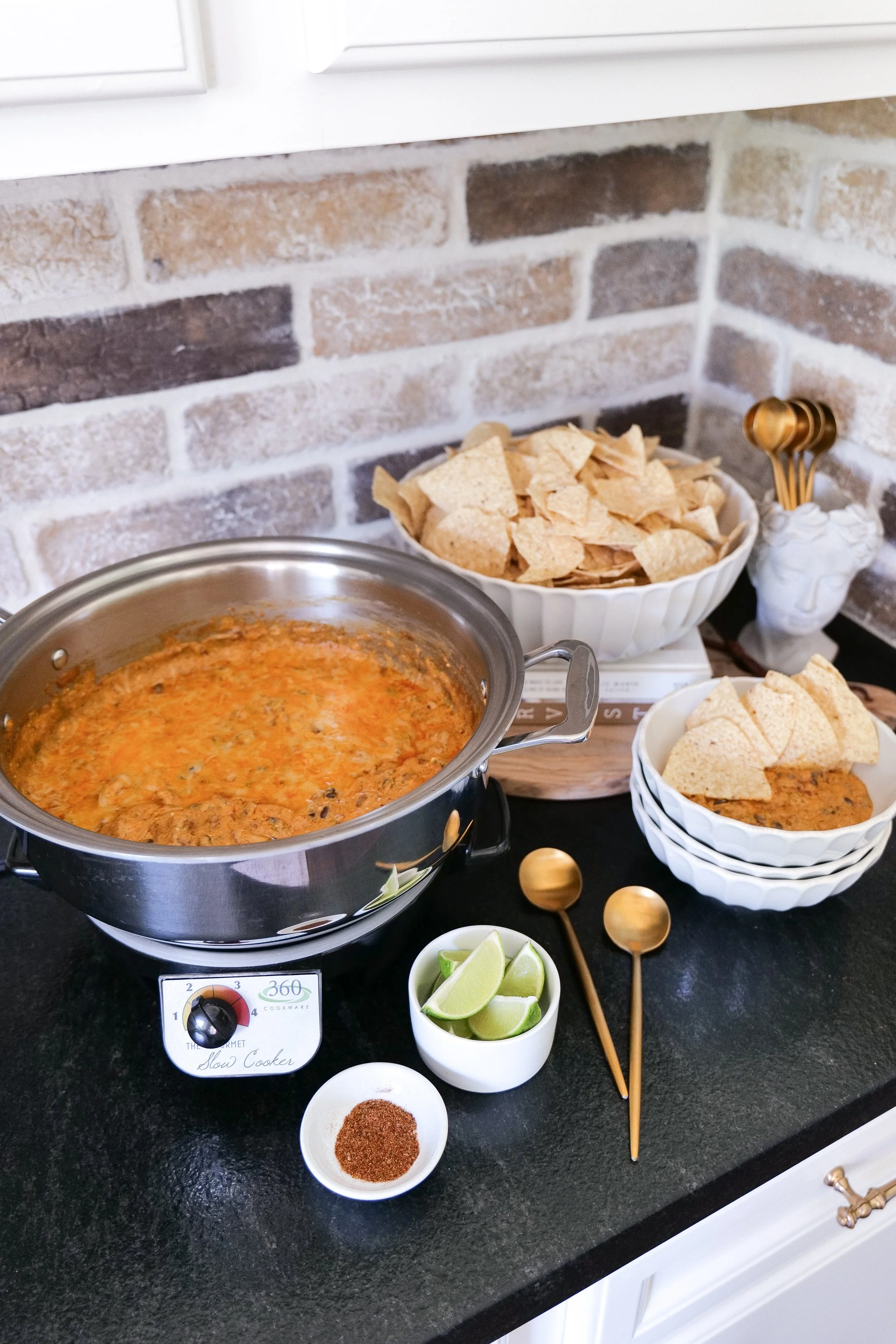 Crockpot chicken enchilada dip with creamy cheese, shredded chicken and black beans.