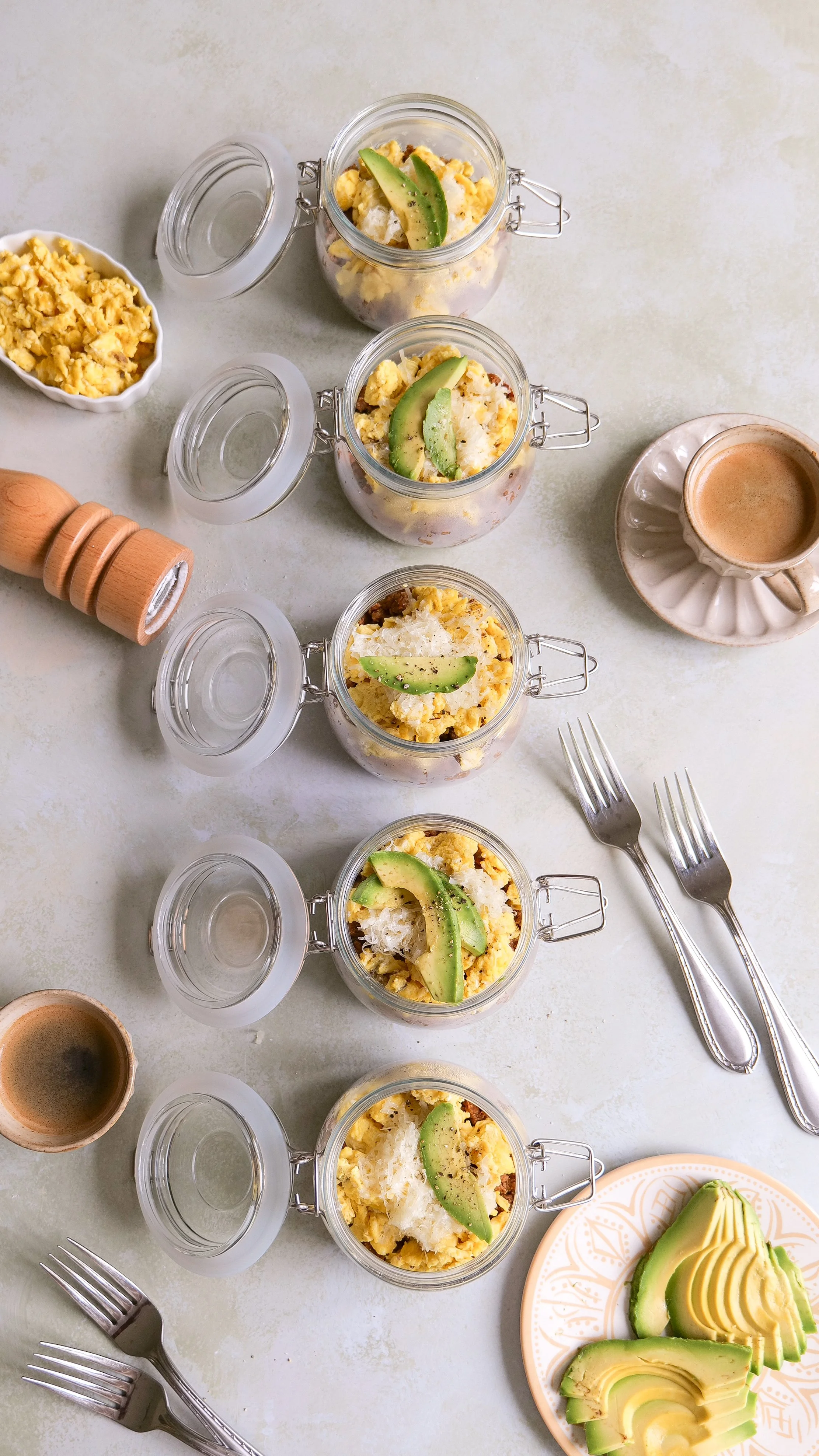 Overhead view of a chorizo potato and egg breakfast bowl with mozzarella and fresh avocado.