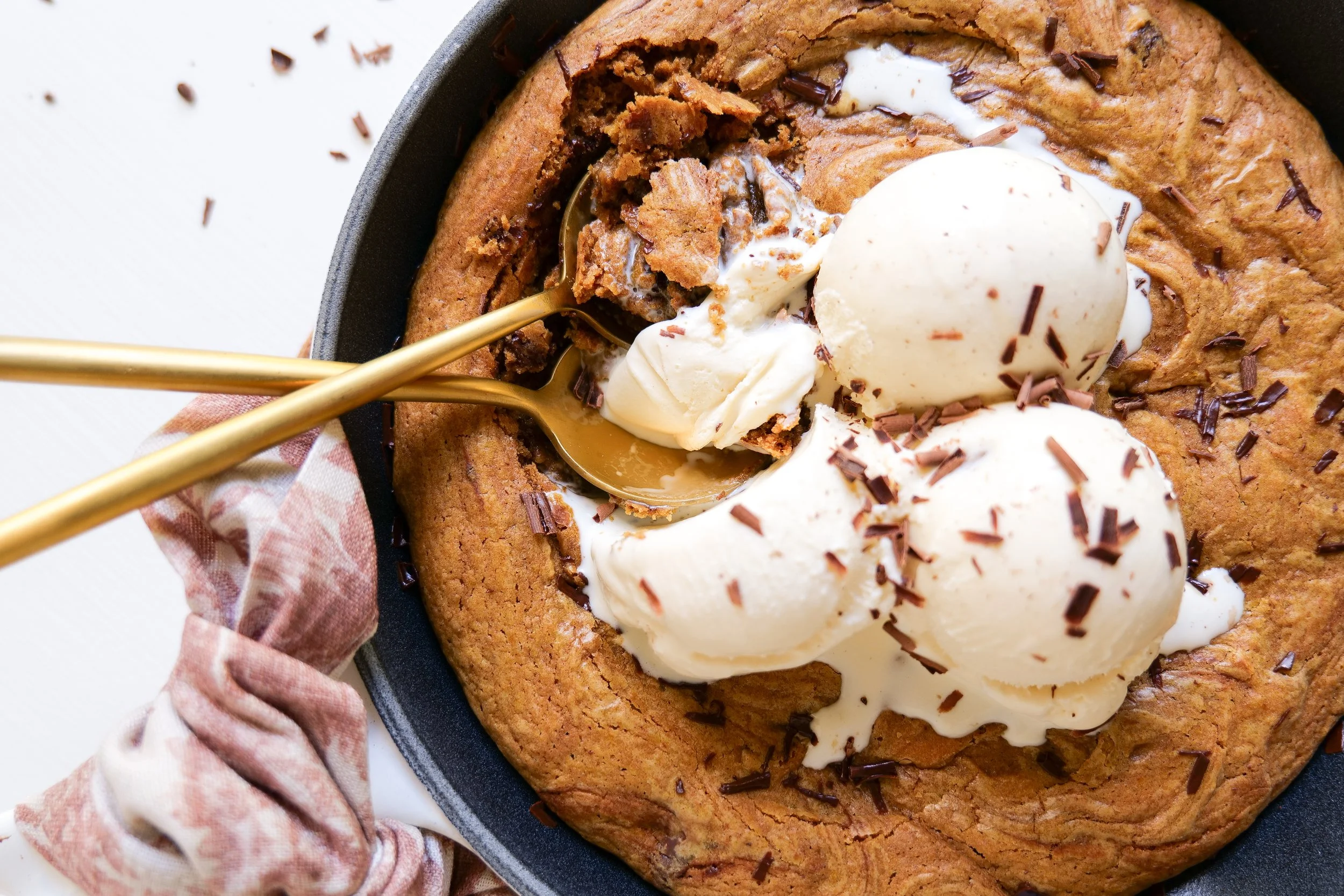 Warm pumpkin skillet cookie served with vanilla ice cream for an easy fall dessert