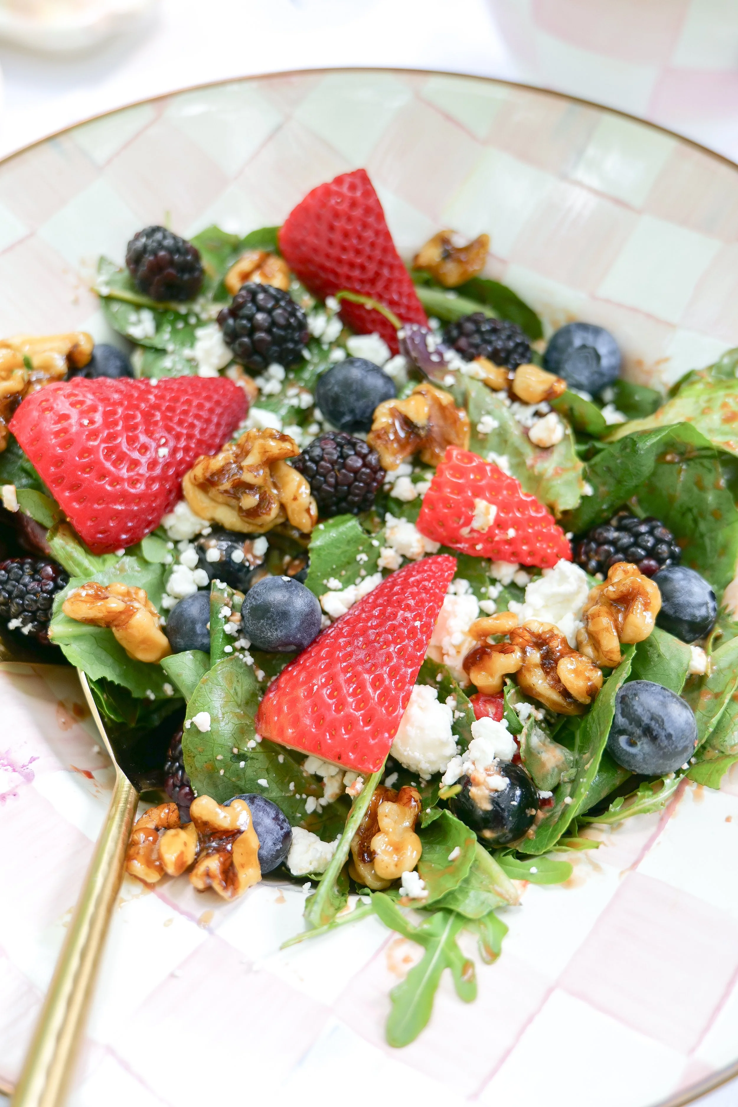 Fresh berry goat cheese salad with spinach, strawberries, blueberries, blackberries and candied walnuts.