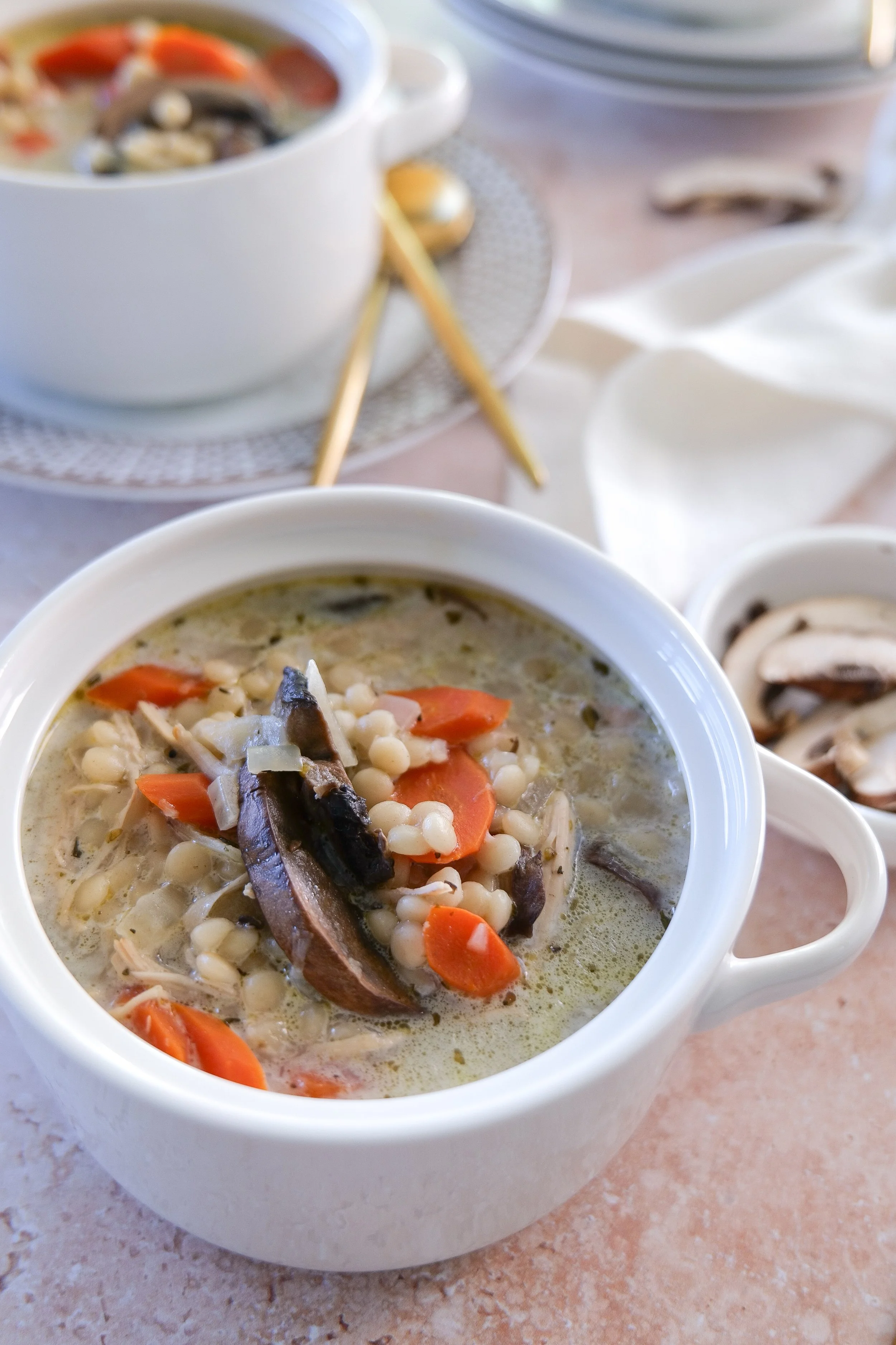 Cozy chicken couscous soup with mushrooms and vegetables served for an easy family dinner.