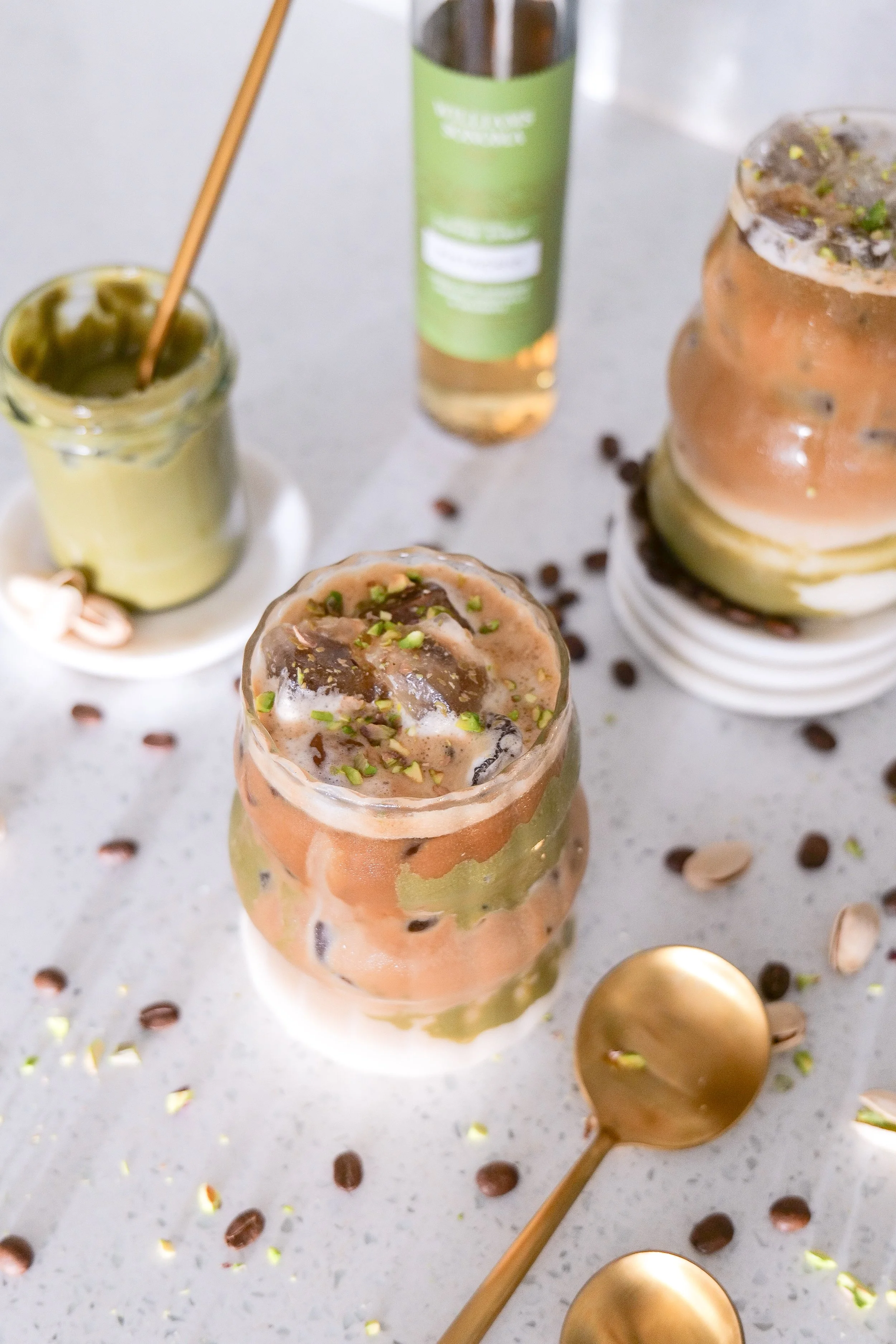 Iced latte flavored with pistachio cream and espresso for a rich nutty coffee drink.