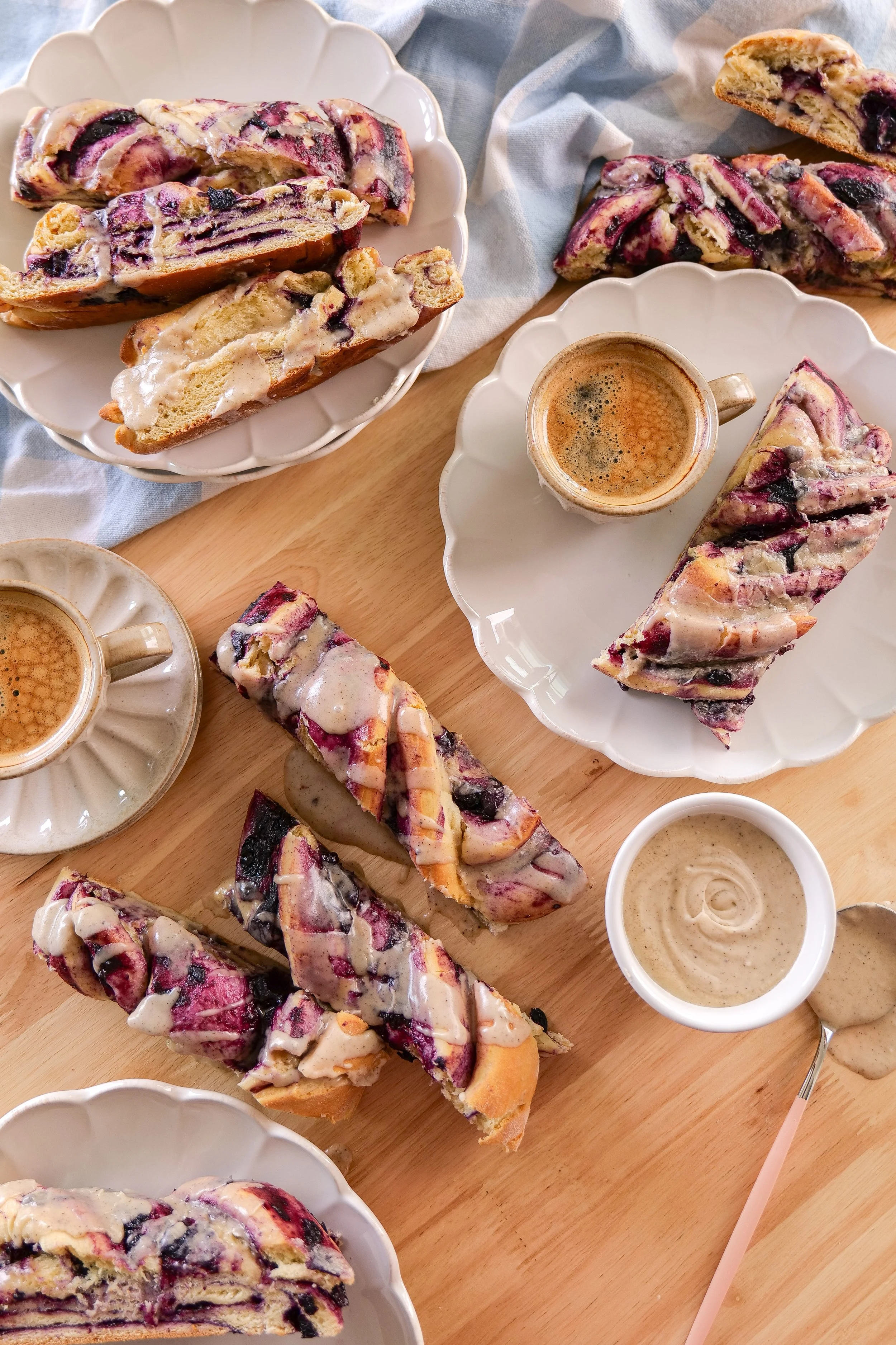 Homemade blueberry cinnamon roll loaf with fresh blueberry filling and brown butter vanilla icing.